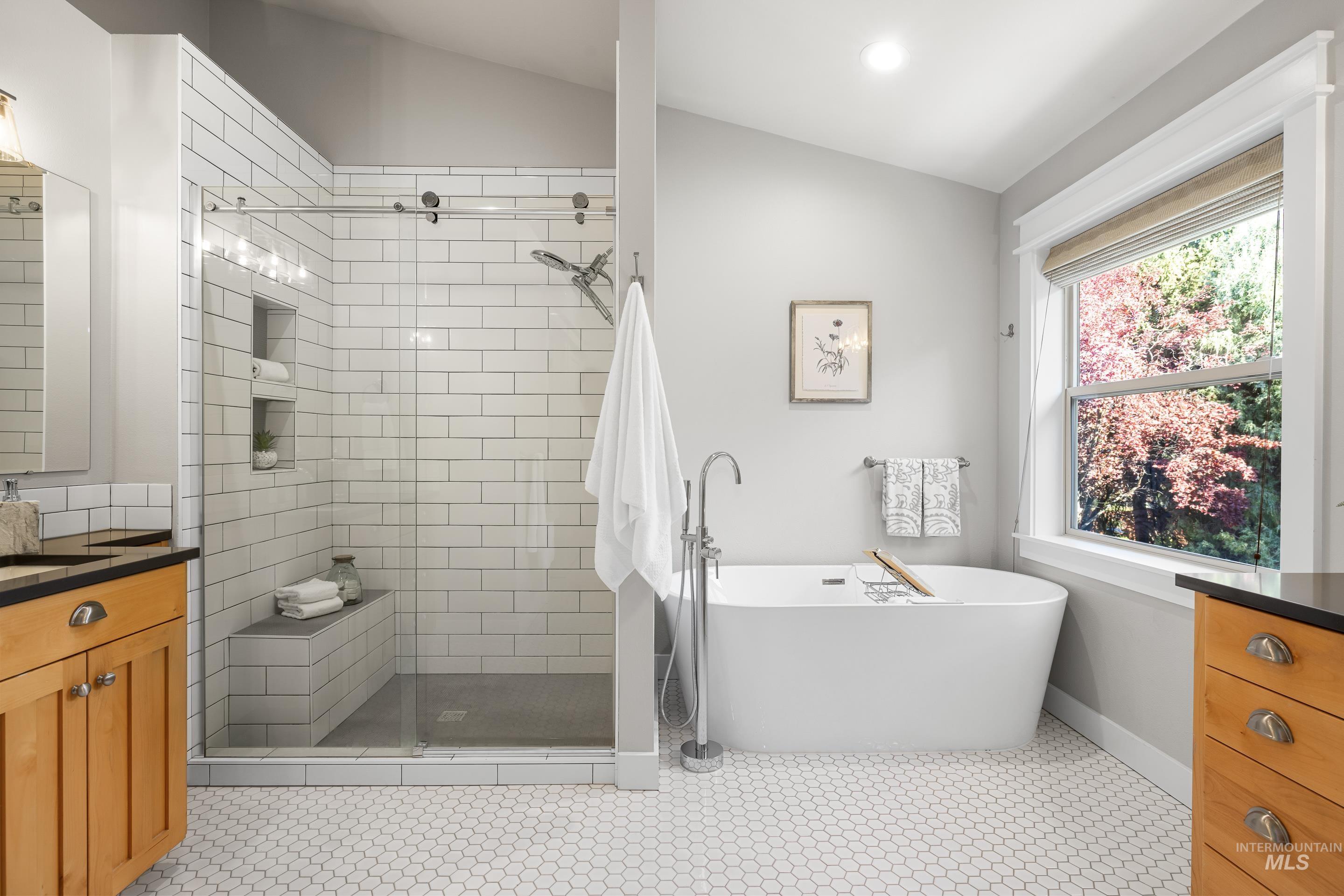 Full bathroom featuring vanity, a soaking tub, a shower stall, recessed lighting, and vaulted ceiling
