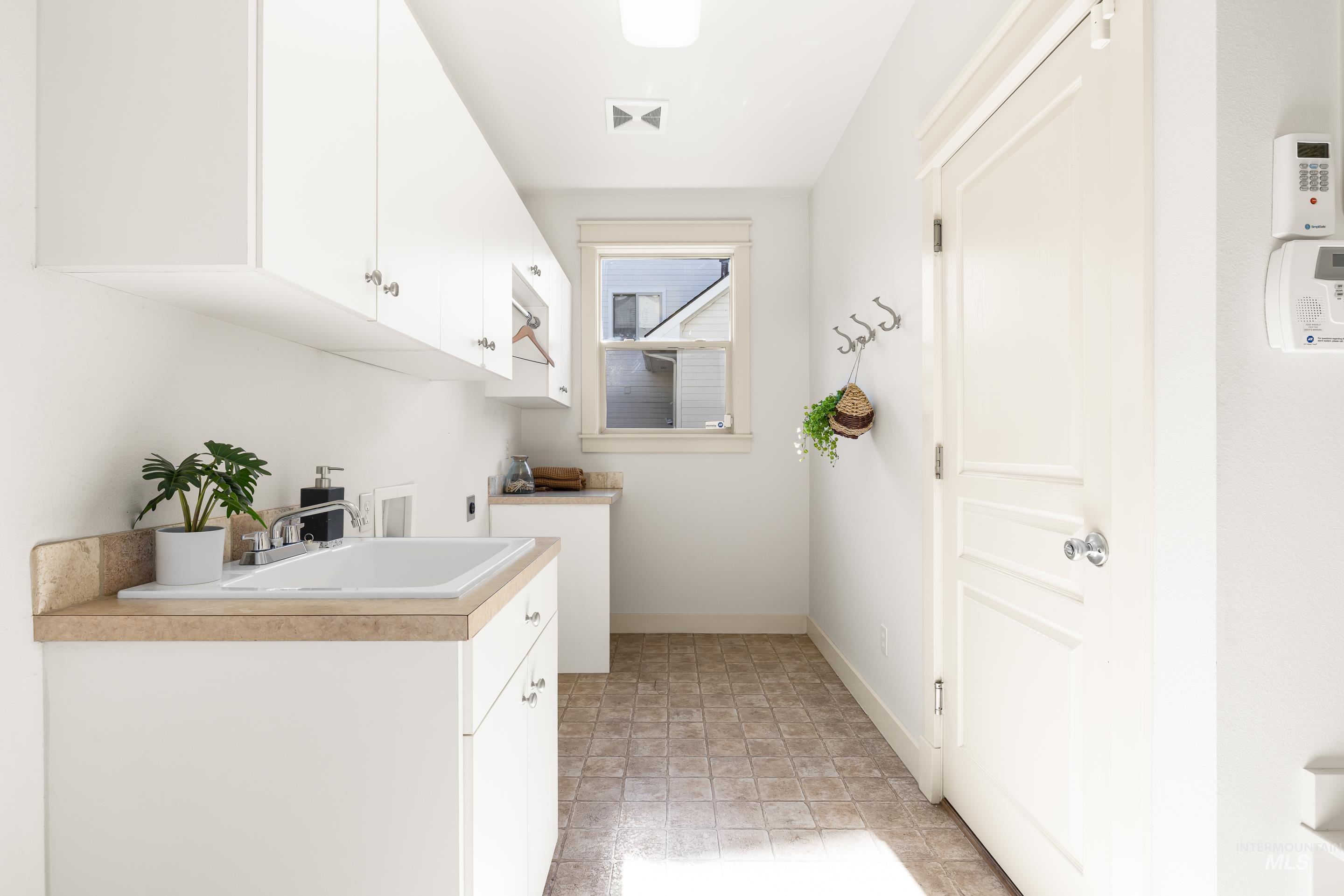 Laundry area featuring cabinet space and baseboards