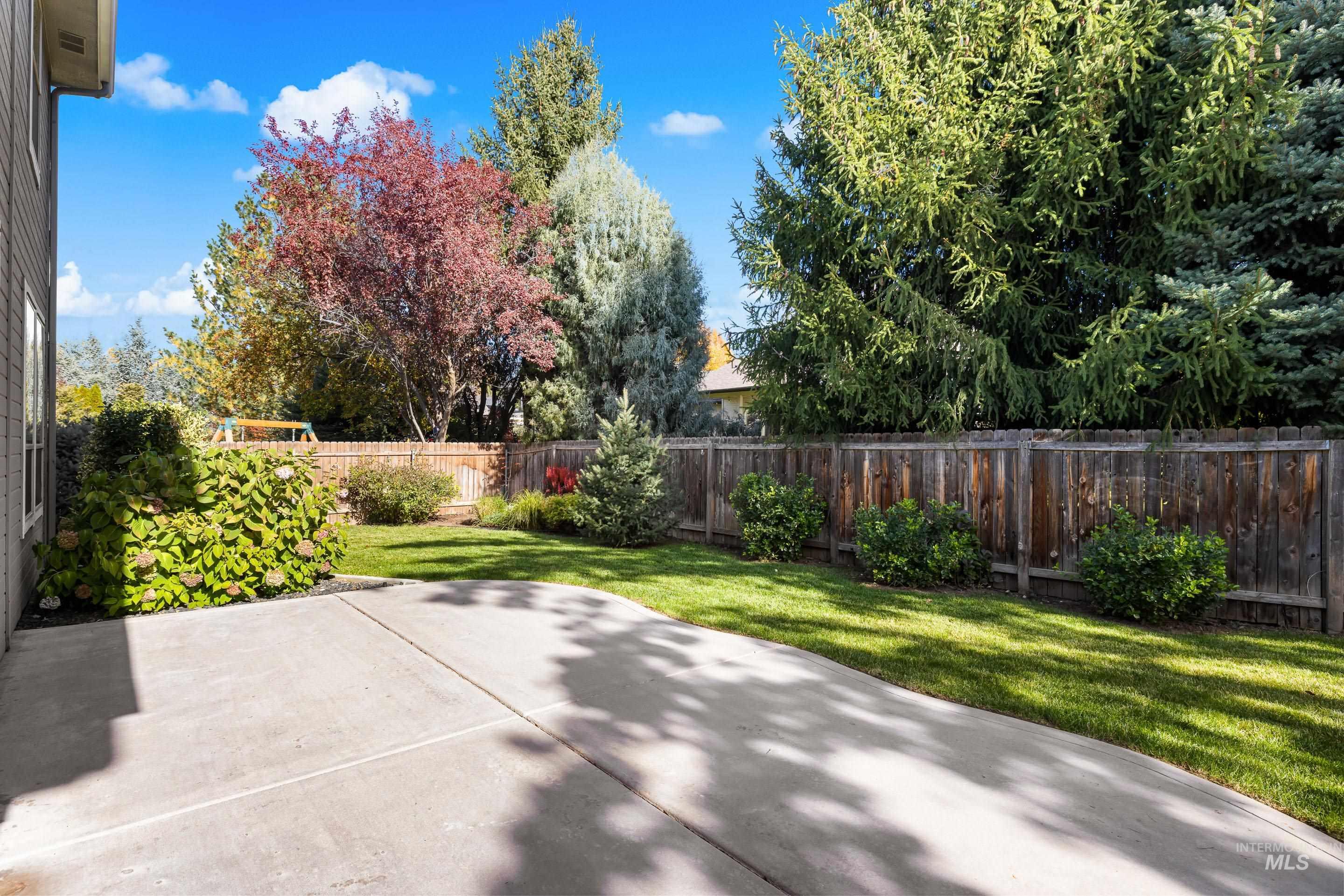 Fenced backyard with a patio area