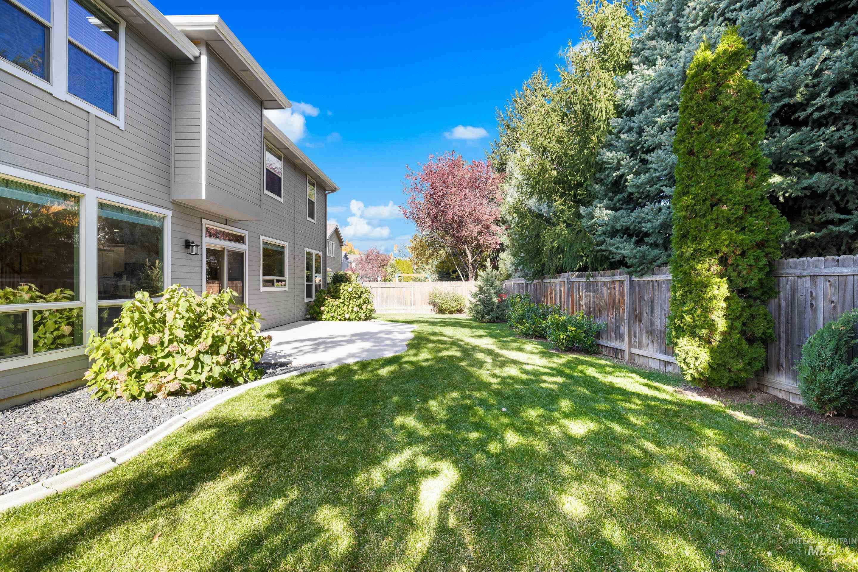Fenced backyard with a patio