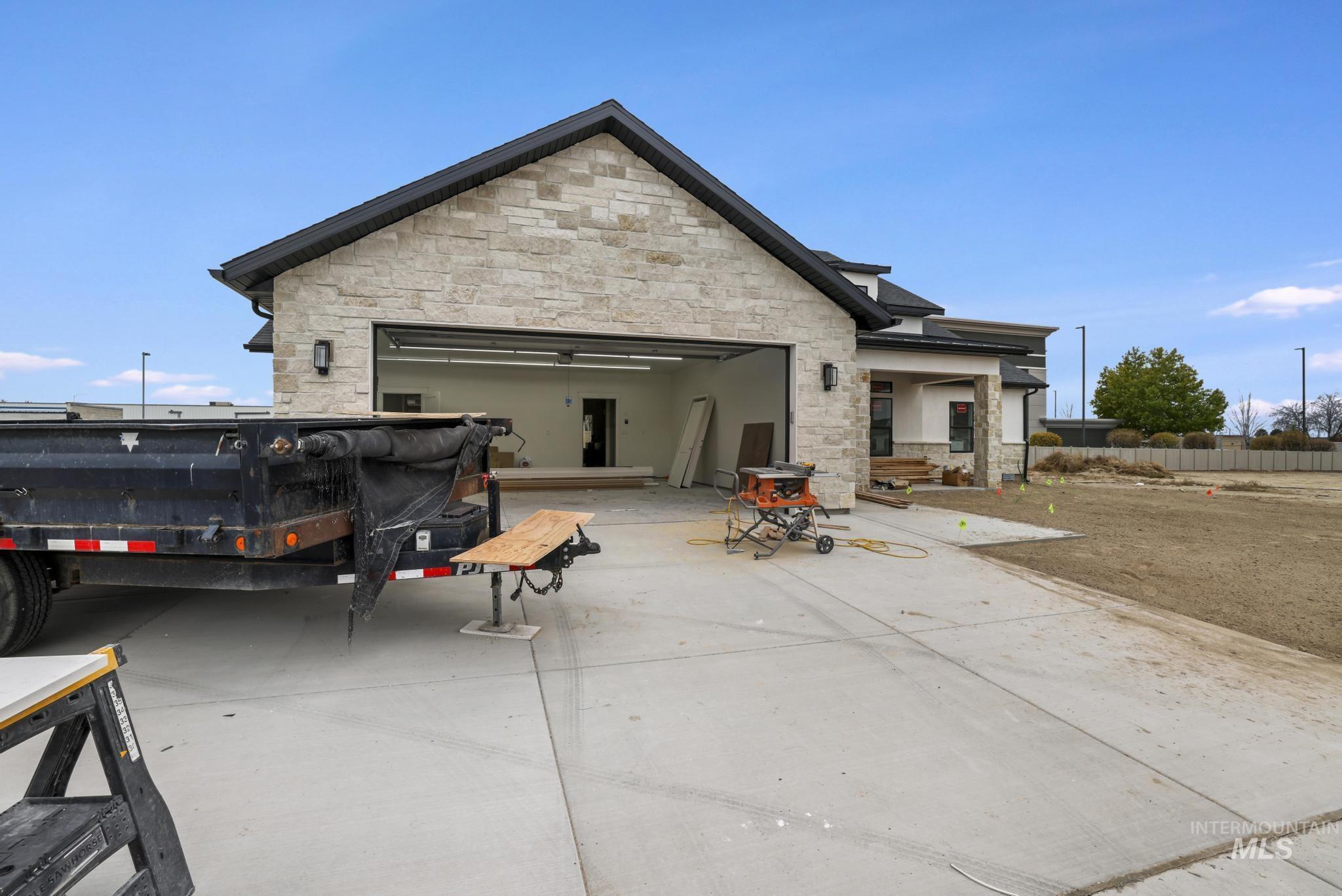 Rear view of property featuring stone siding