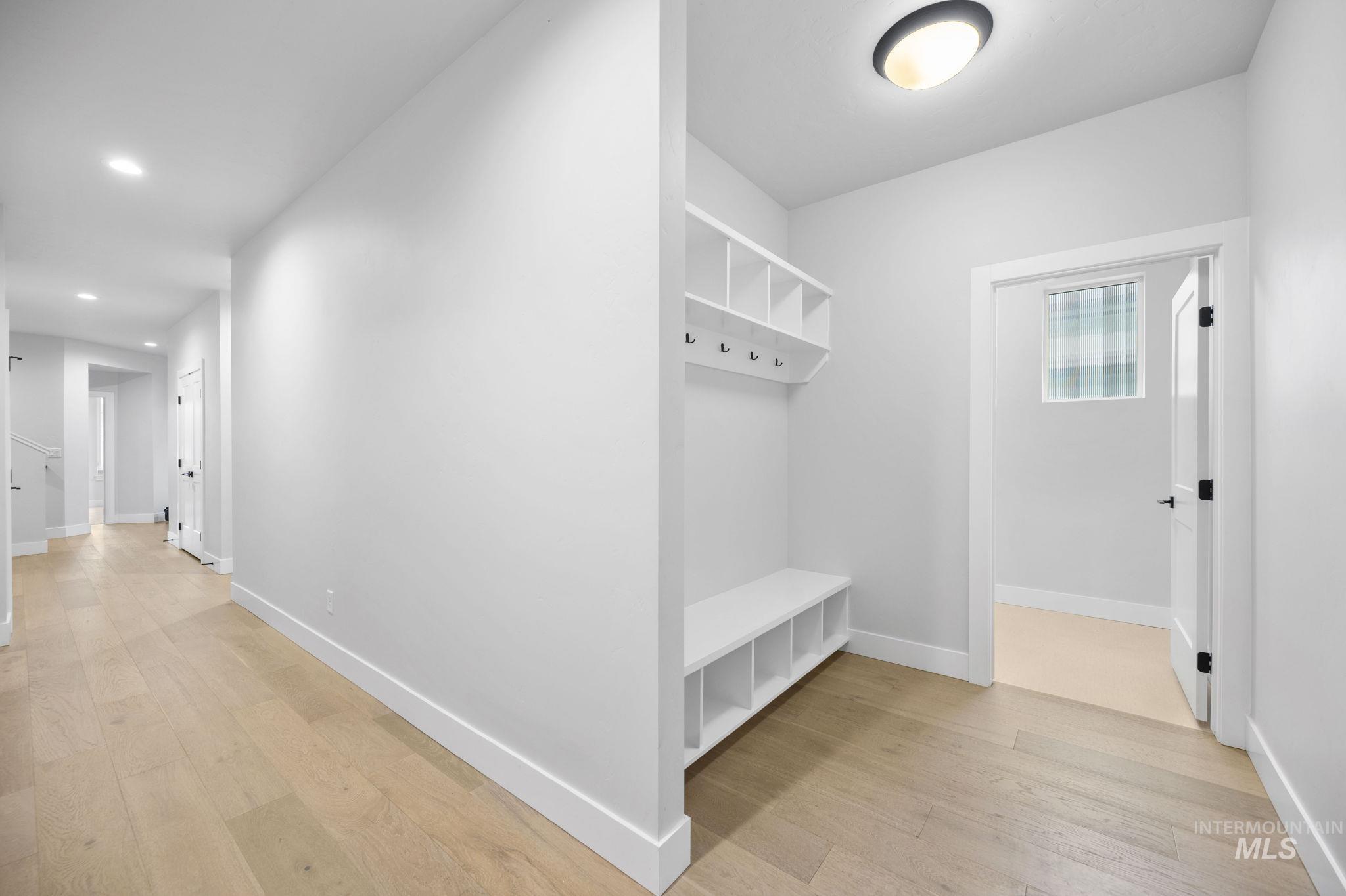 Mudroom featuring light wood finished floors and recessed lighting