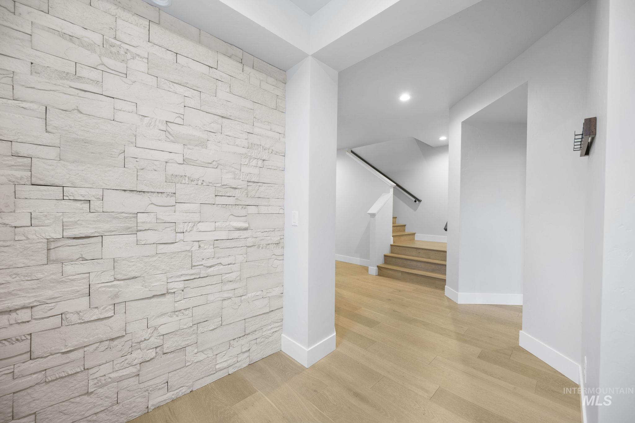 Hall with recessed lighting, stairway, and light wood-type flooring