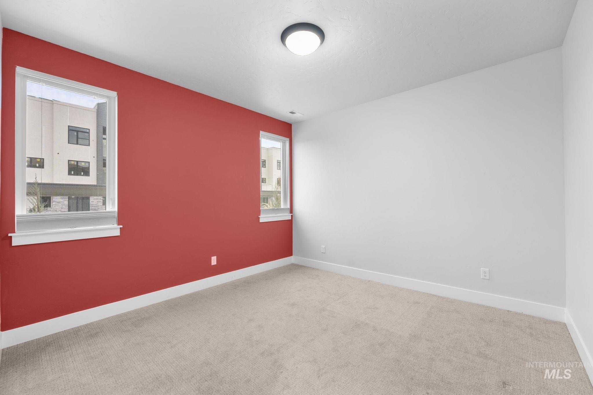 Carpeted empty room featuring baseboards