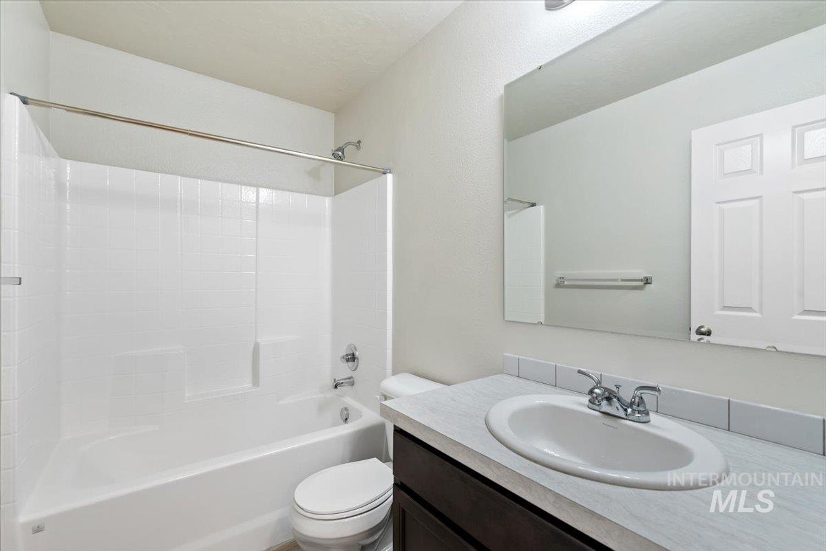 Bathroom with shower / bathtub combination and vanity