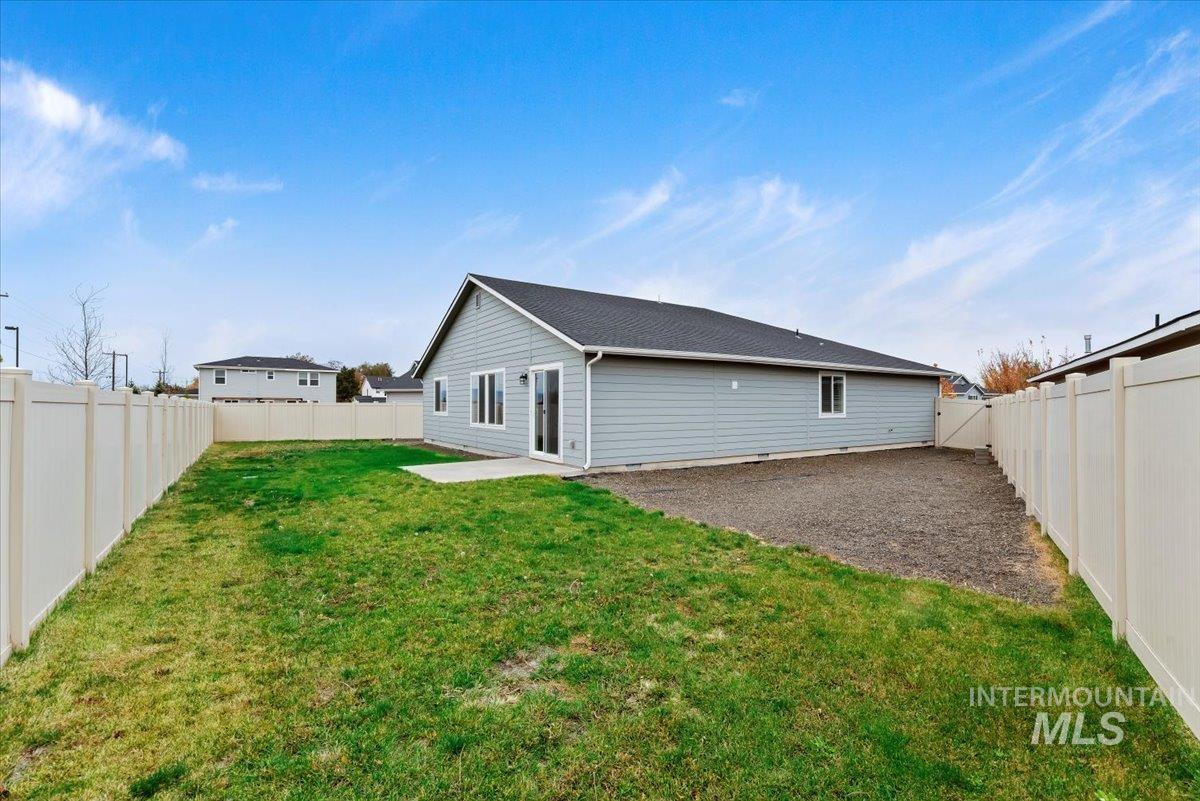 Rear view of house featuring a patio and a fenced backyard