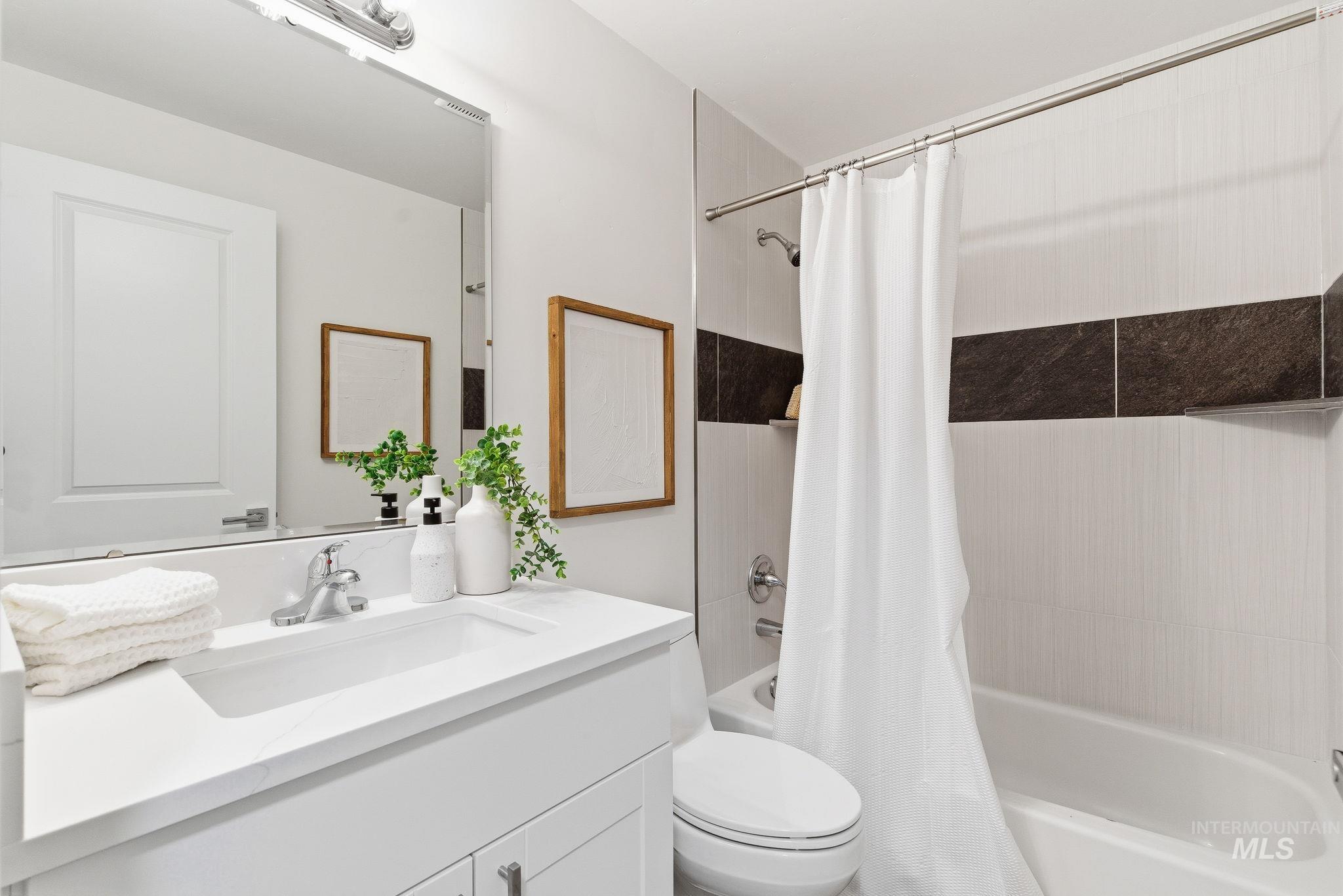 Bathroom featuring shower / tub combo and vanity