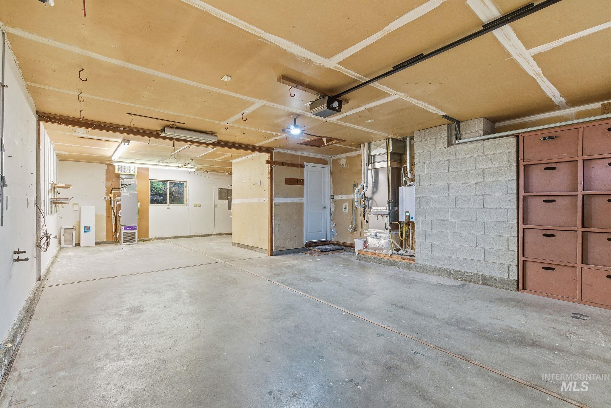Garage with water heater and a garage door opener