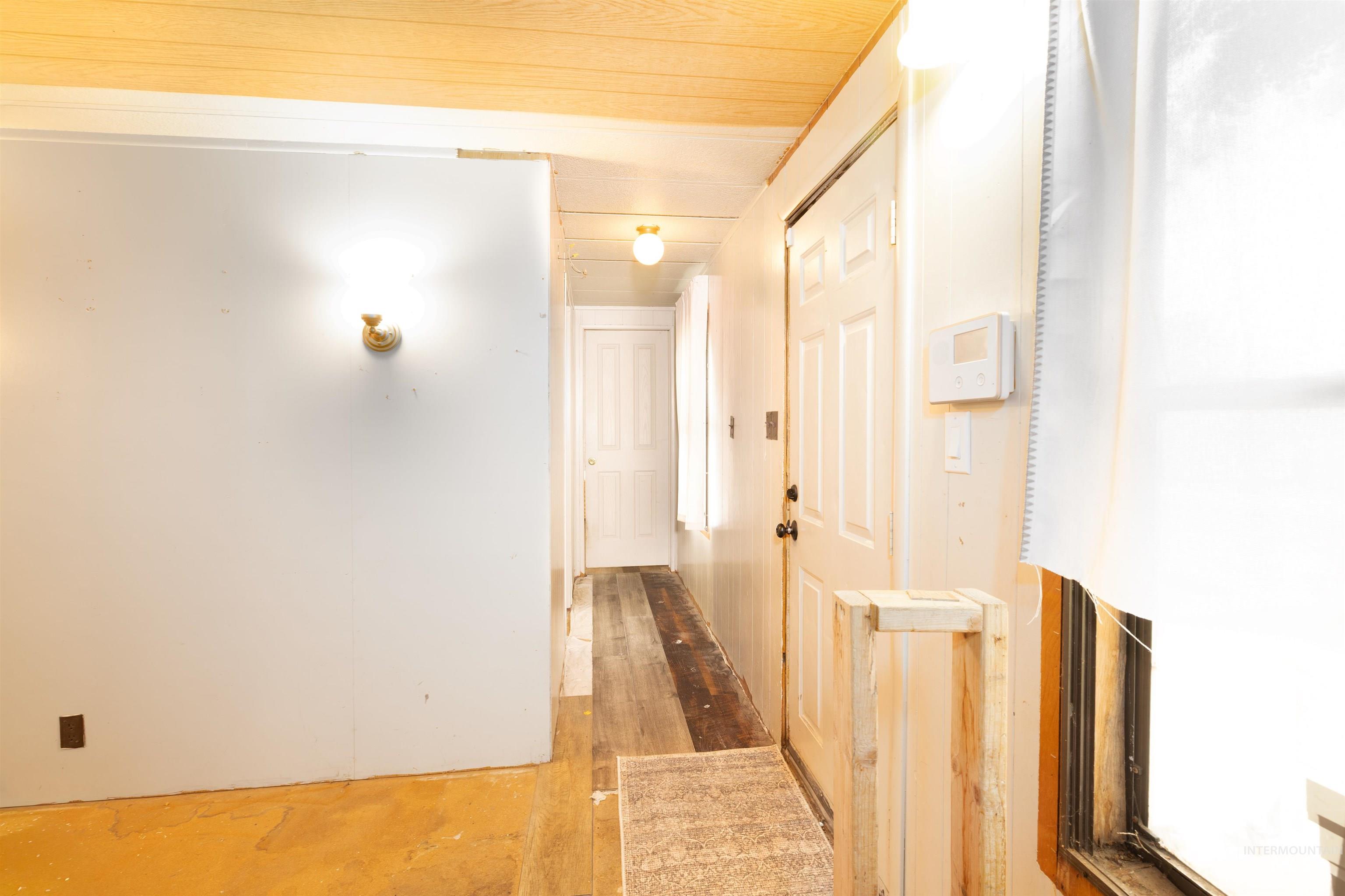Hallway with hardwood / wood-style flooring