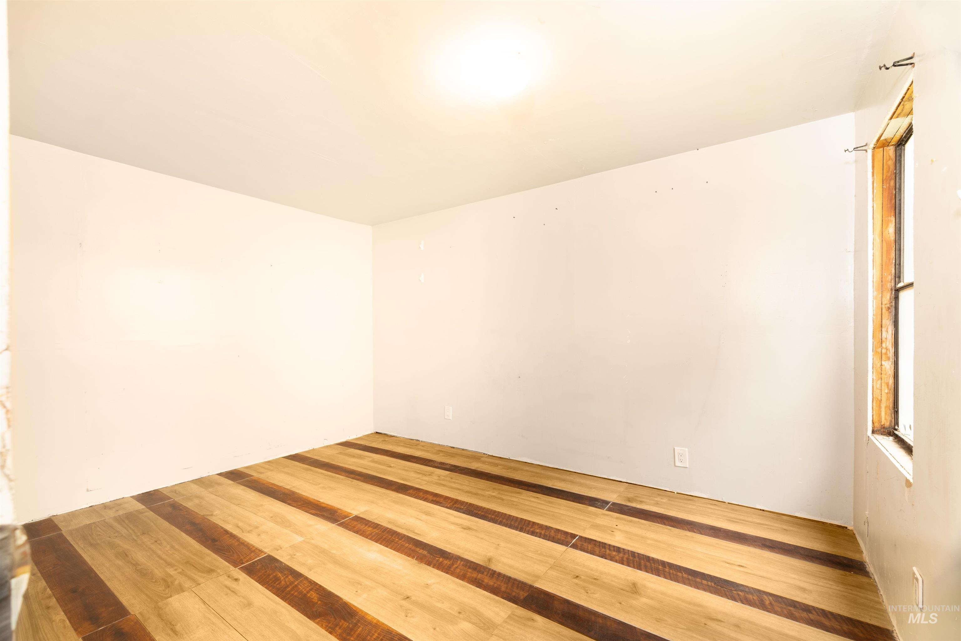 Unfurnished room featuring wood-type flooring