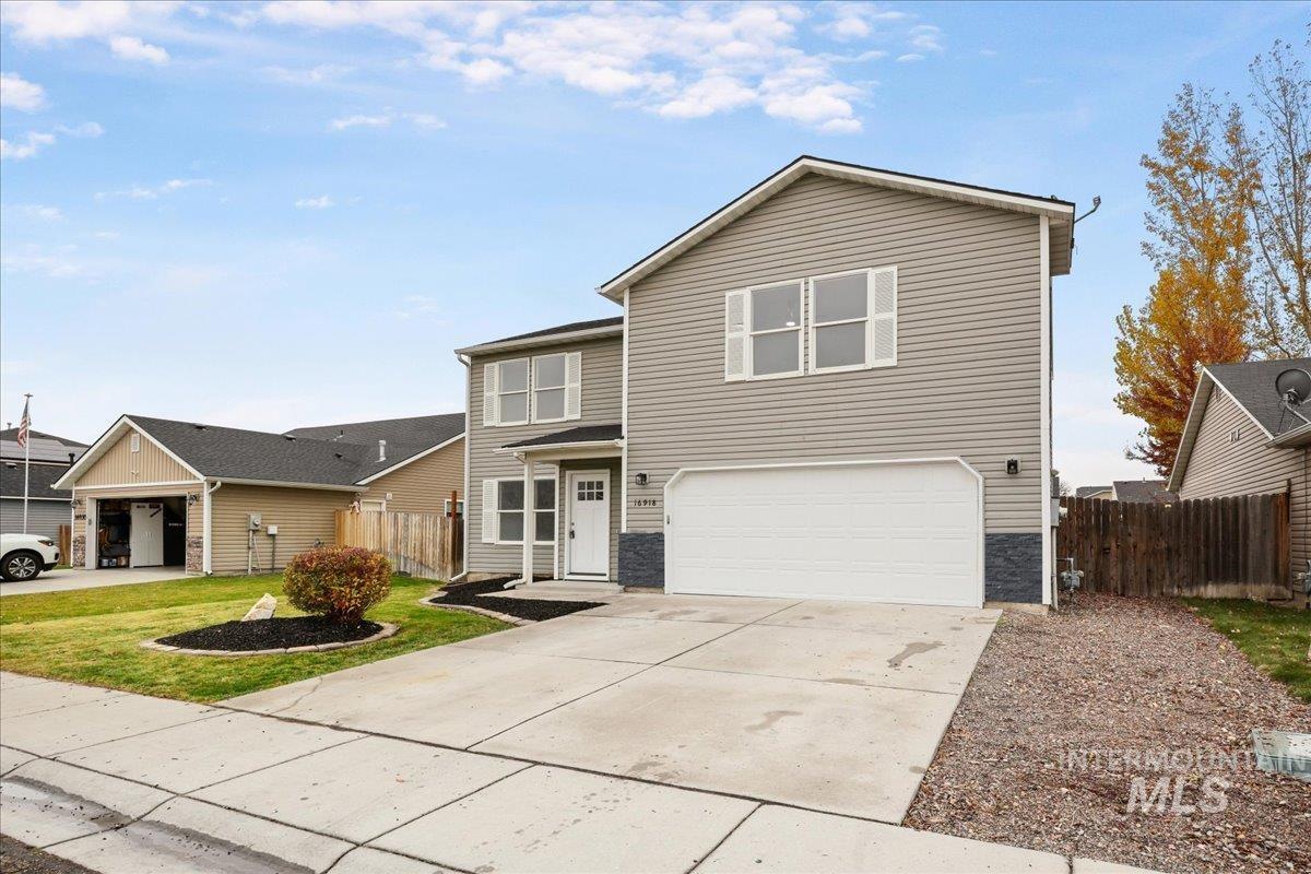 Traditional-style home featuring concrete driveway and an attached garage