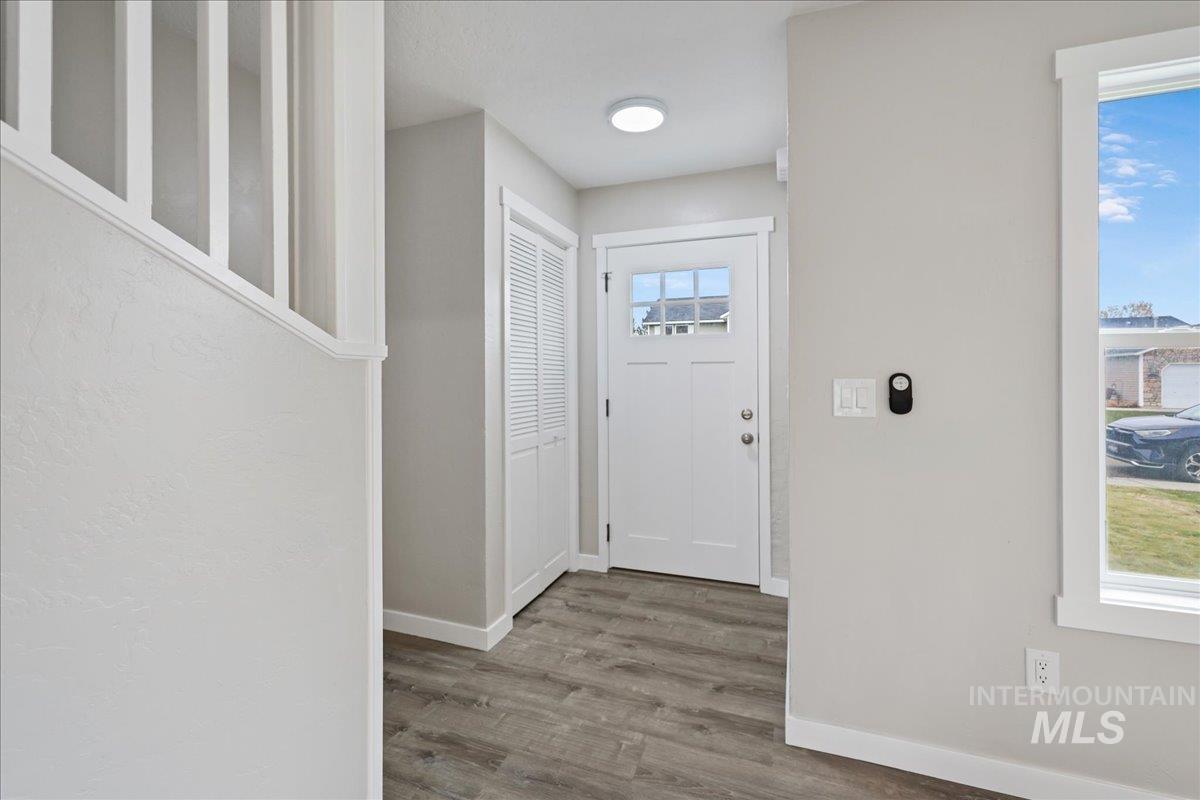 Foyer featuring baseboards and wood finished floors