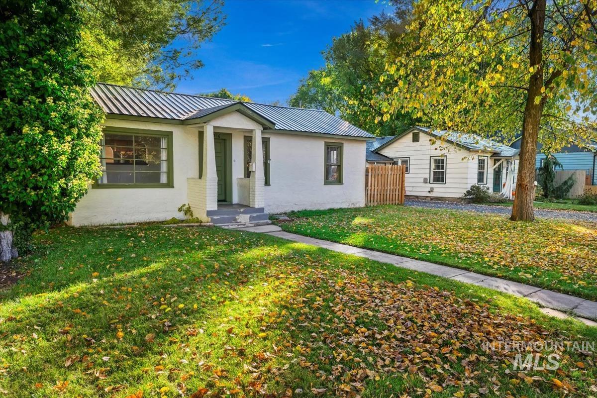 View of front facade with a metal roof and brick siding