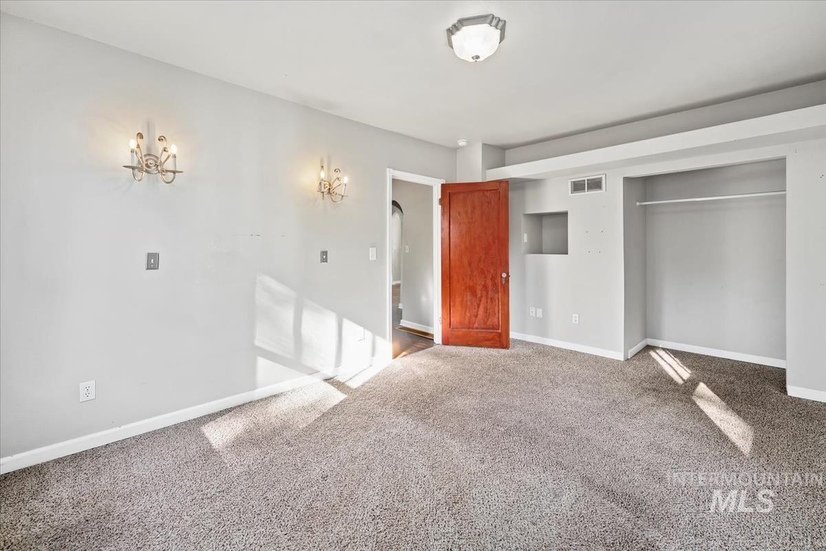 Unfurnished bedroom with carpet floors and a closet