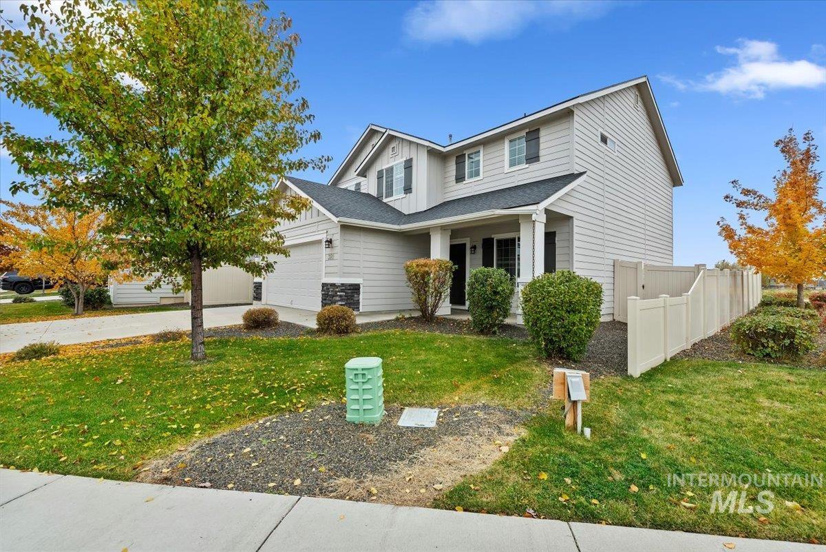 View of front of property with board and batten siding, driveway, a porch, and a garage