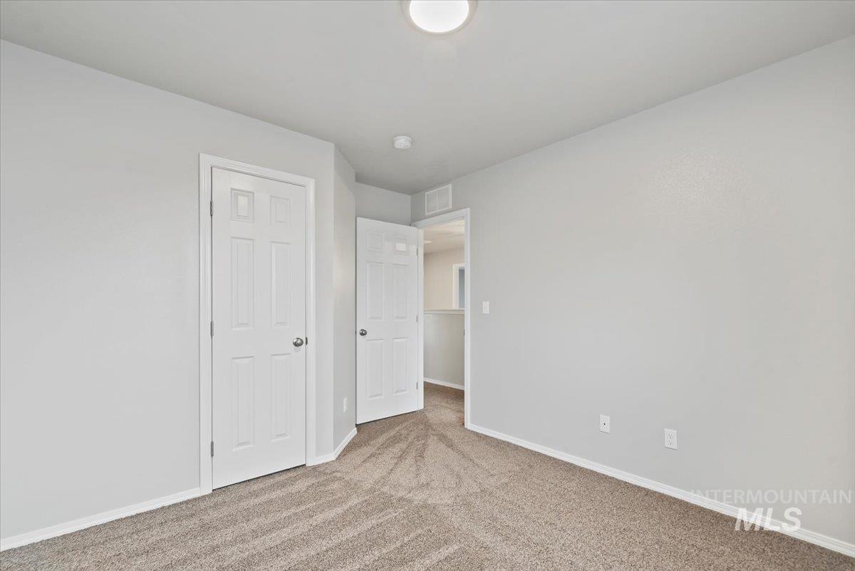 Unfurnished bedroom featuring carpet flooring and baseboards