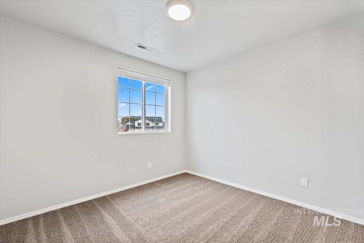 Unfurnished room featuring carpet and baseboards