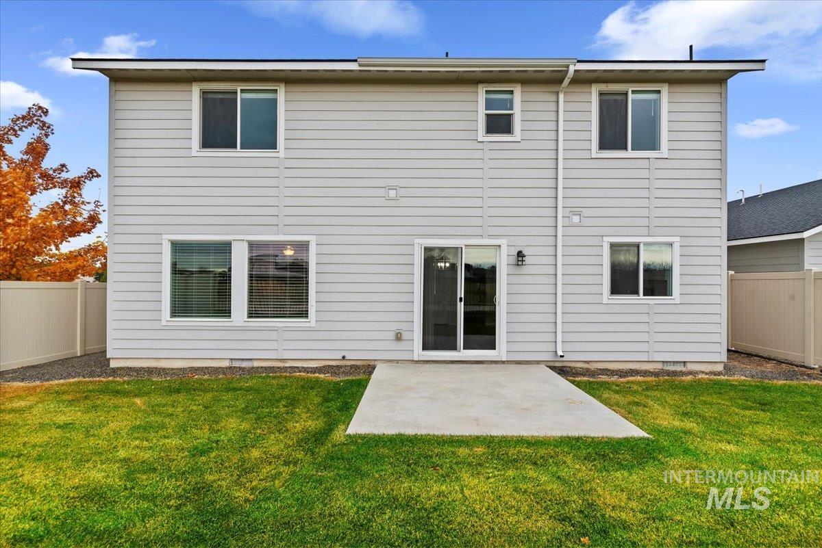 Back of property with a fenced backyard and a patio area