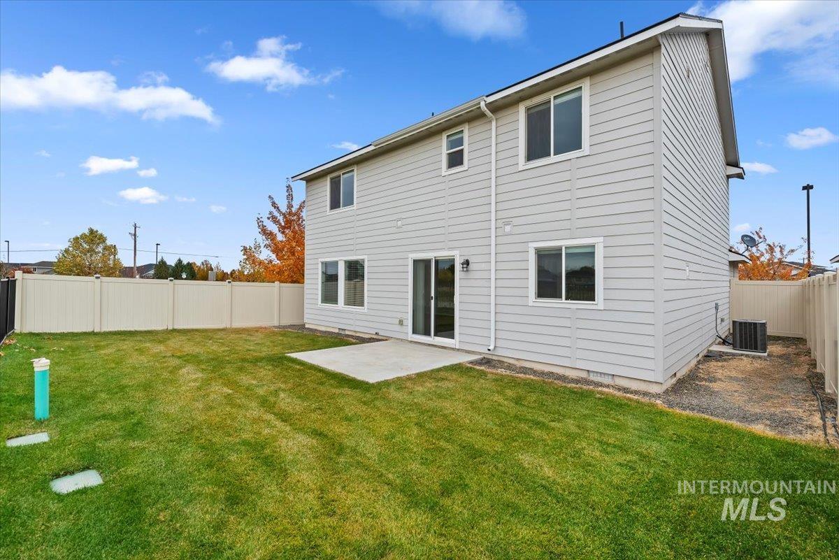 Rear view of property with a patio and a fenced backyard