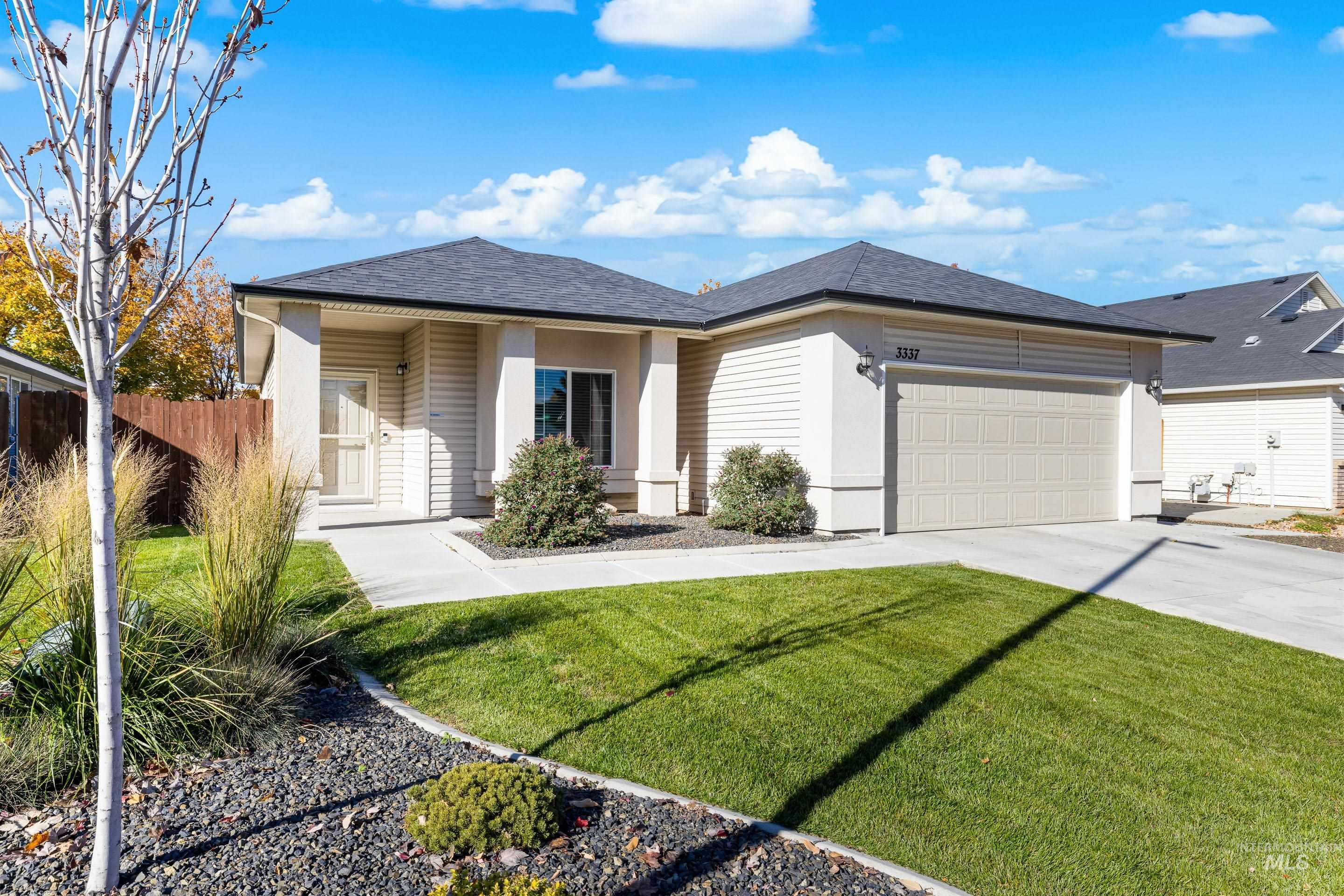 View of front of house featuring driveway, a garage, and roof with shingles