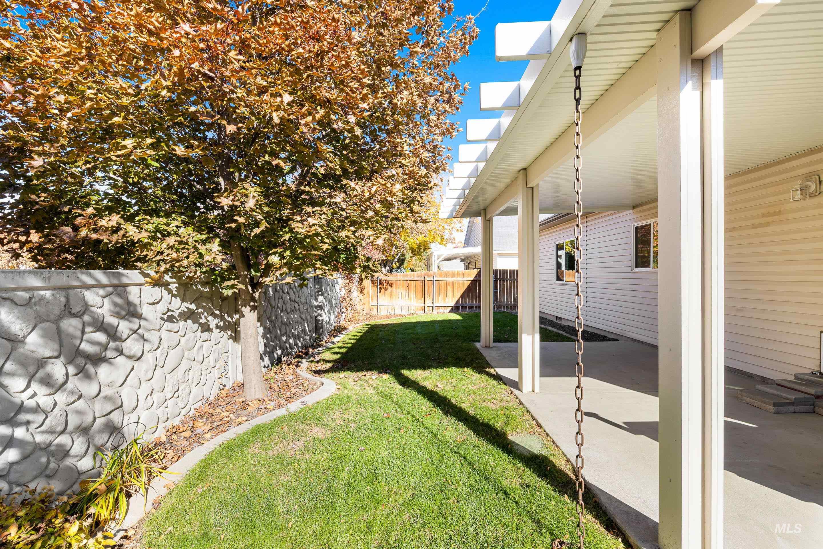 Fenced backyard with a patio area