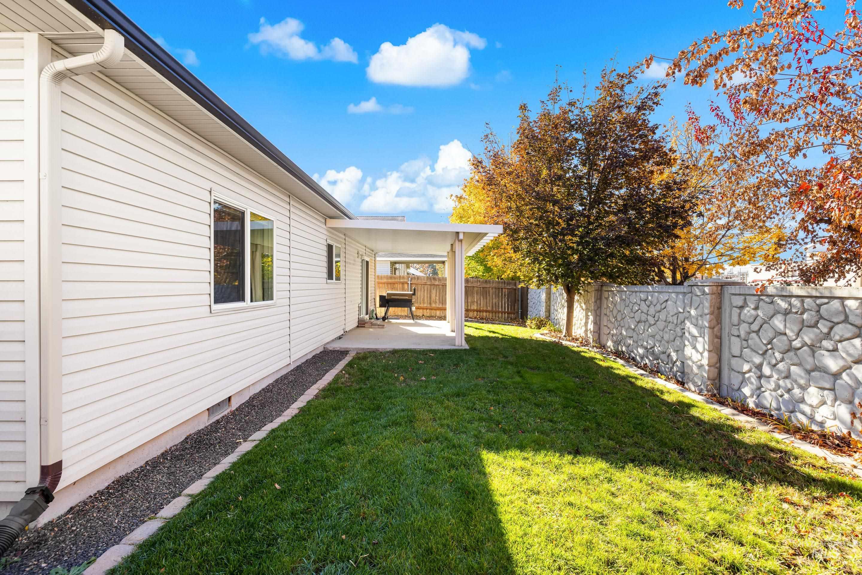 Fenced backyard featuring a patio