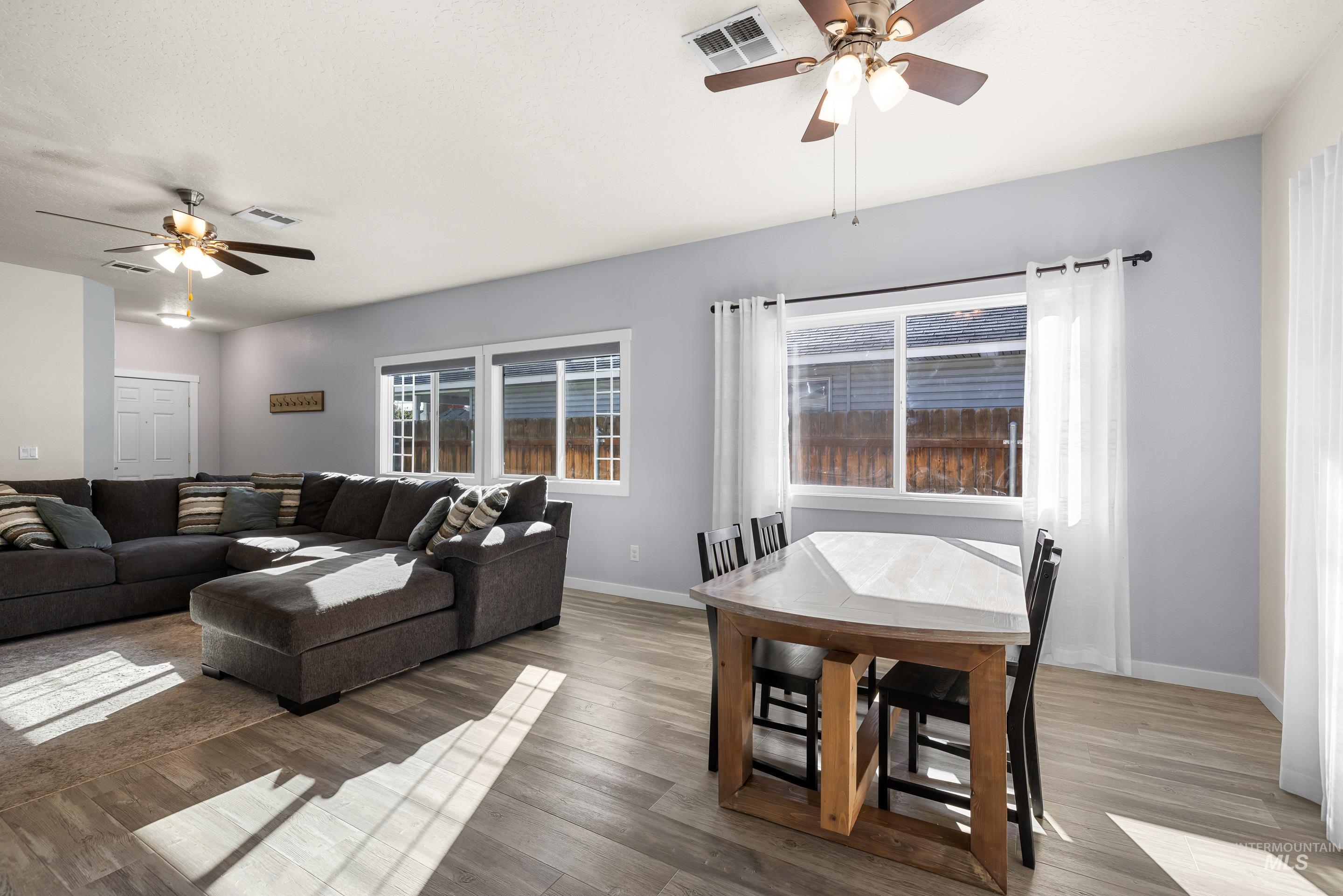 Living area featuring a ceiling fan and wood finished floors