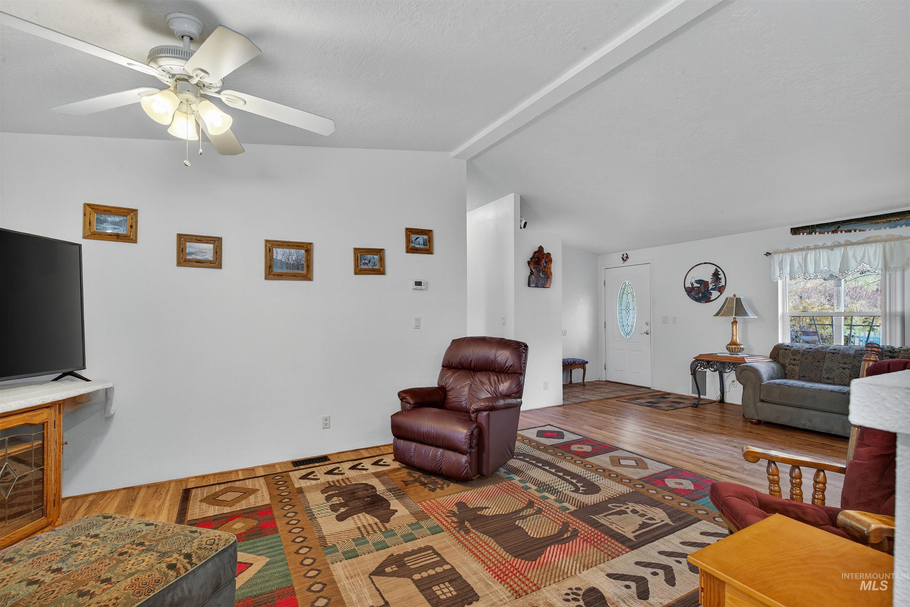 Living room with wood finished floors and a ceiling fan