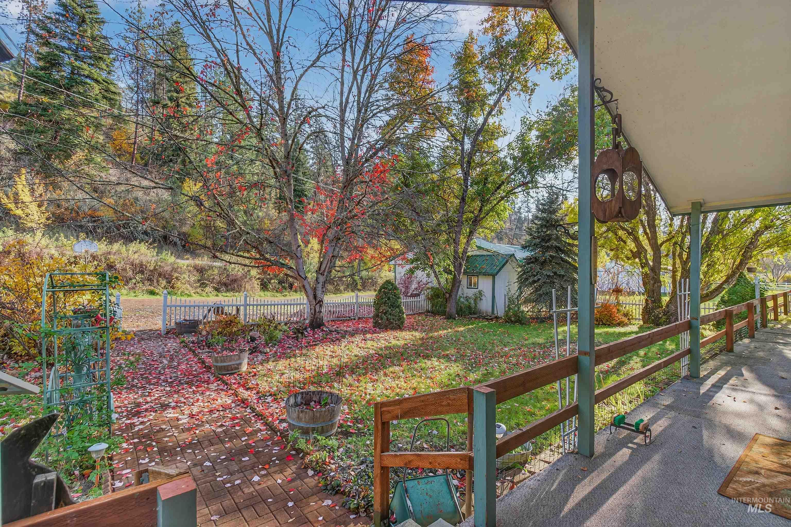 Fenced backyard featuring an outbuilding