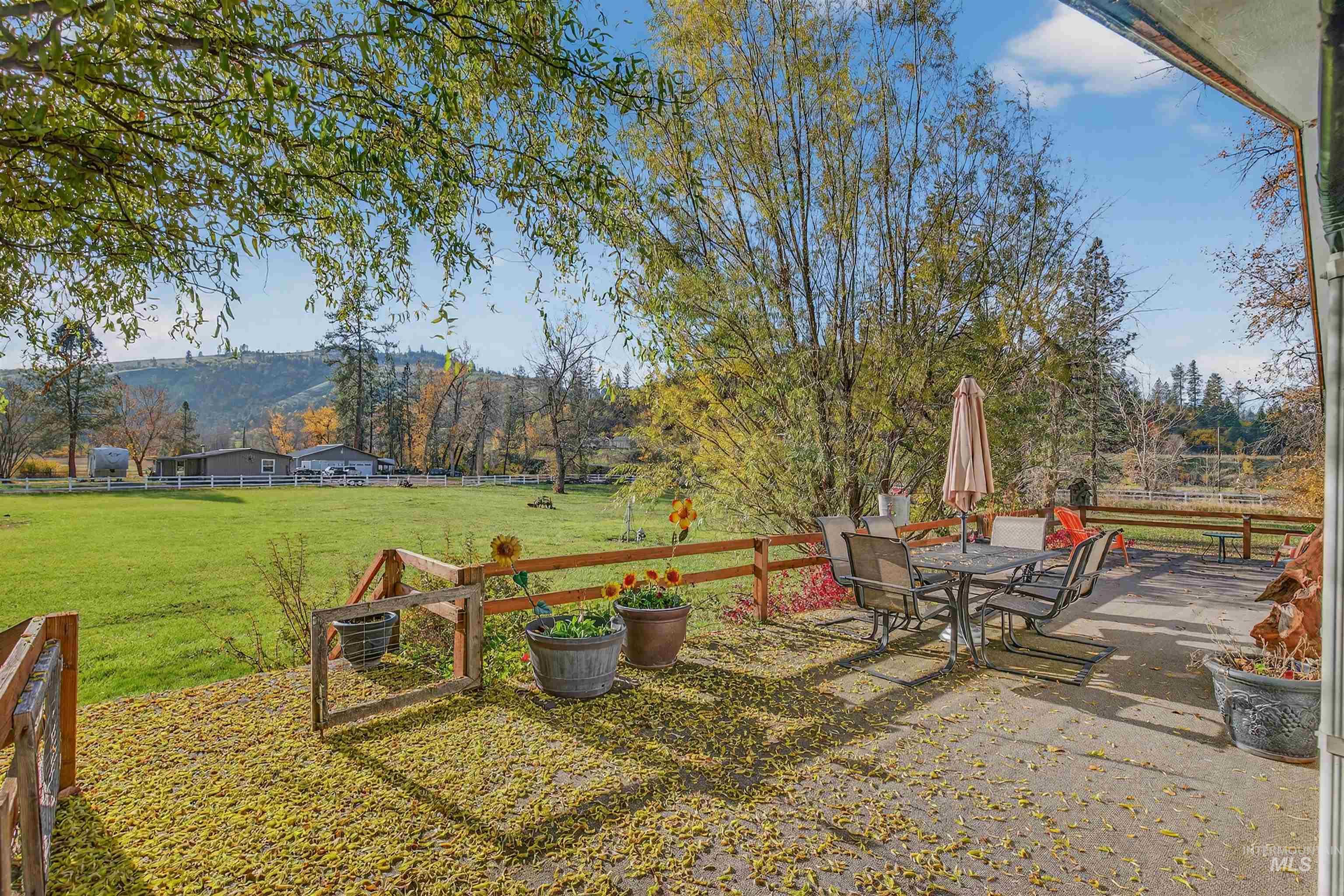 View of yard featuring outdoor dining area and a view of countryside