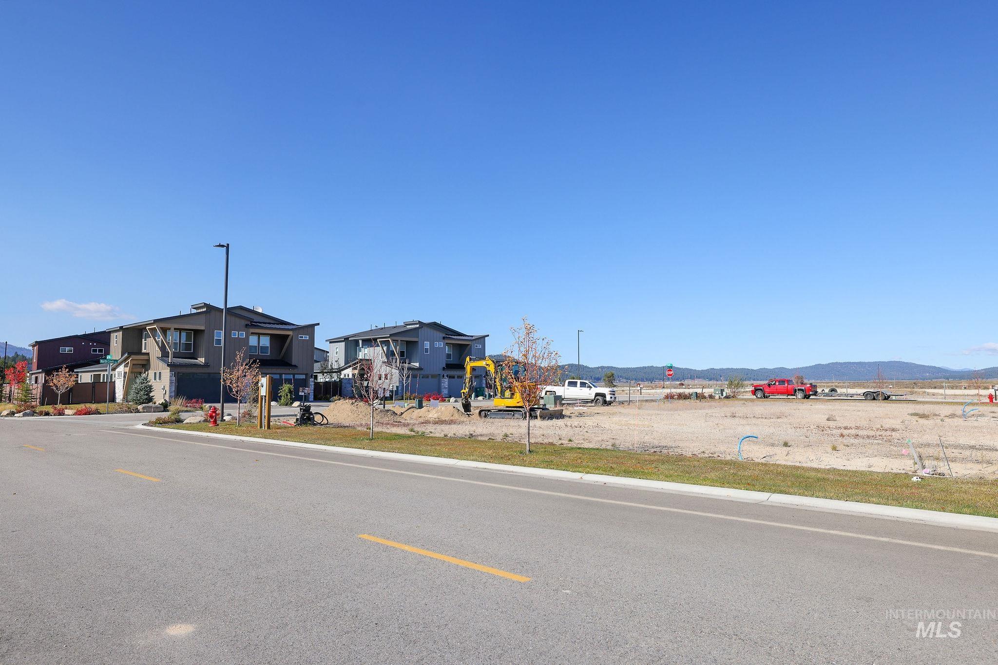 View of asphalt street with street lighting and a mountain view