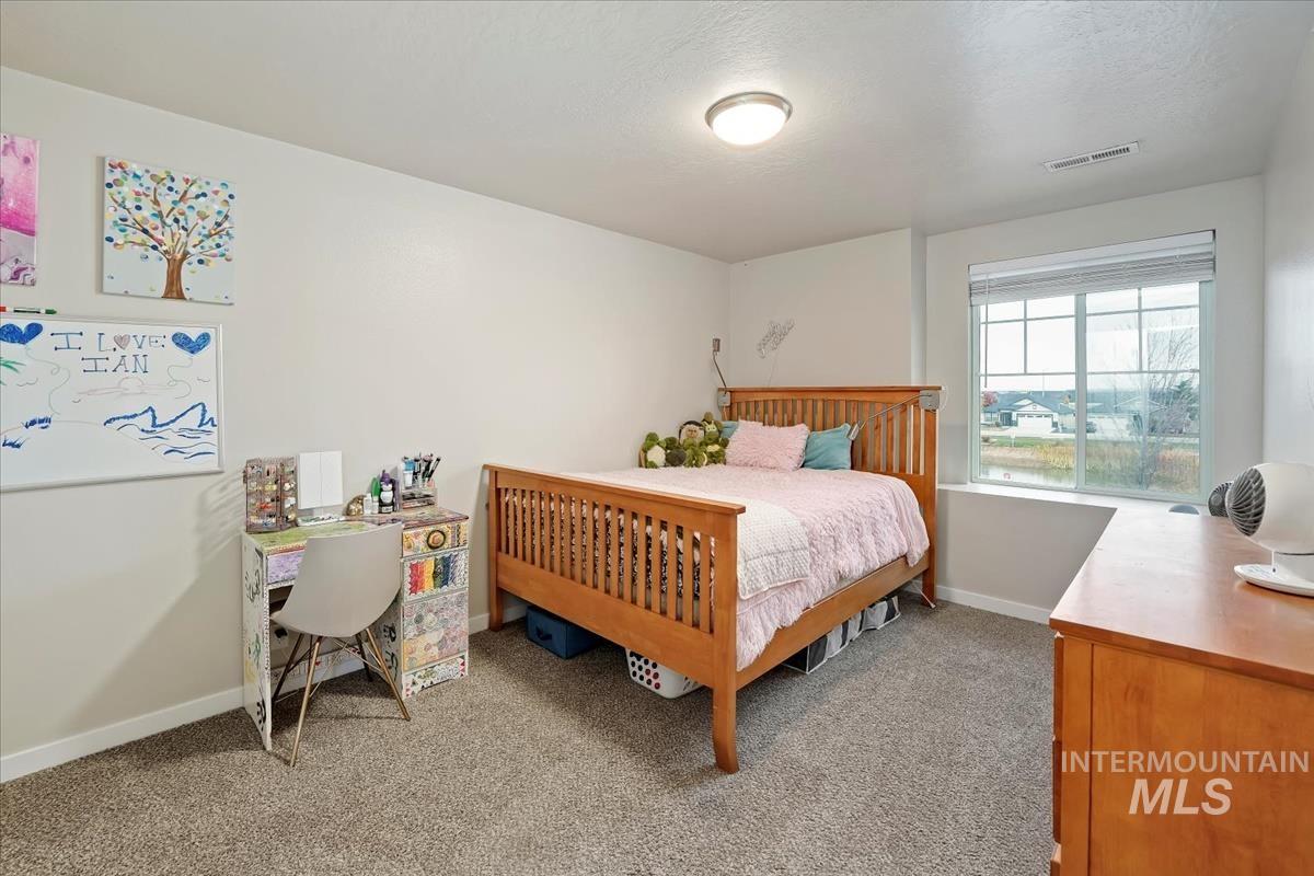 Carpeted bedroom featuring a textured ceiling