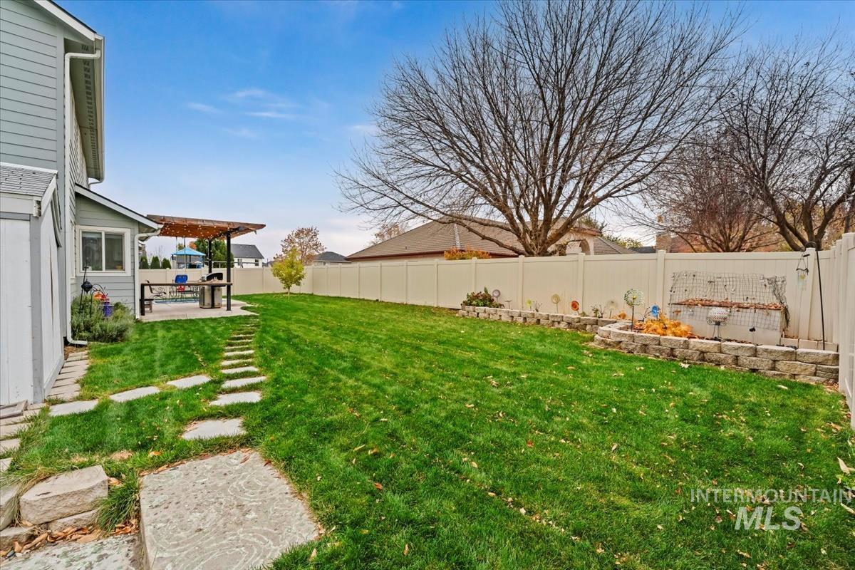 Fenced backyard with a patio area