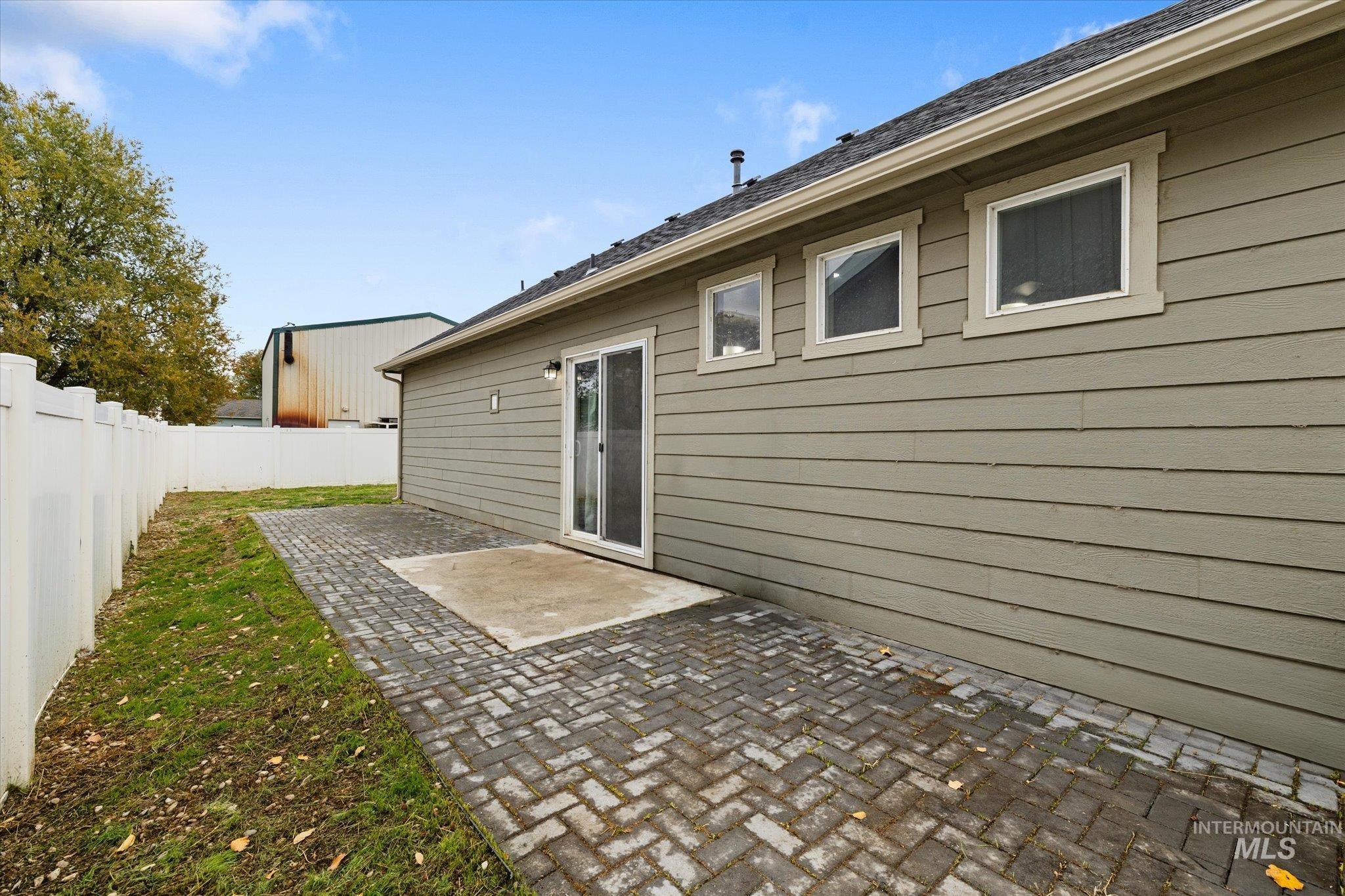 Back of property with a fenced backyard and a patio area