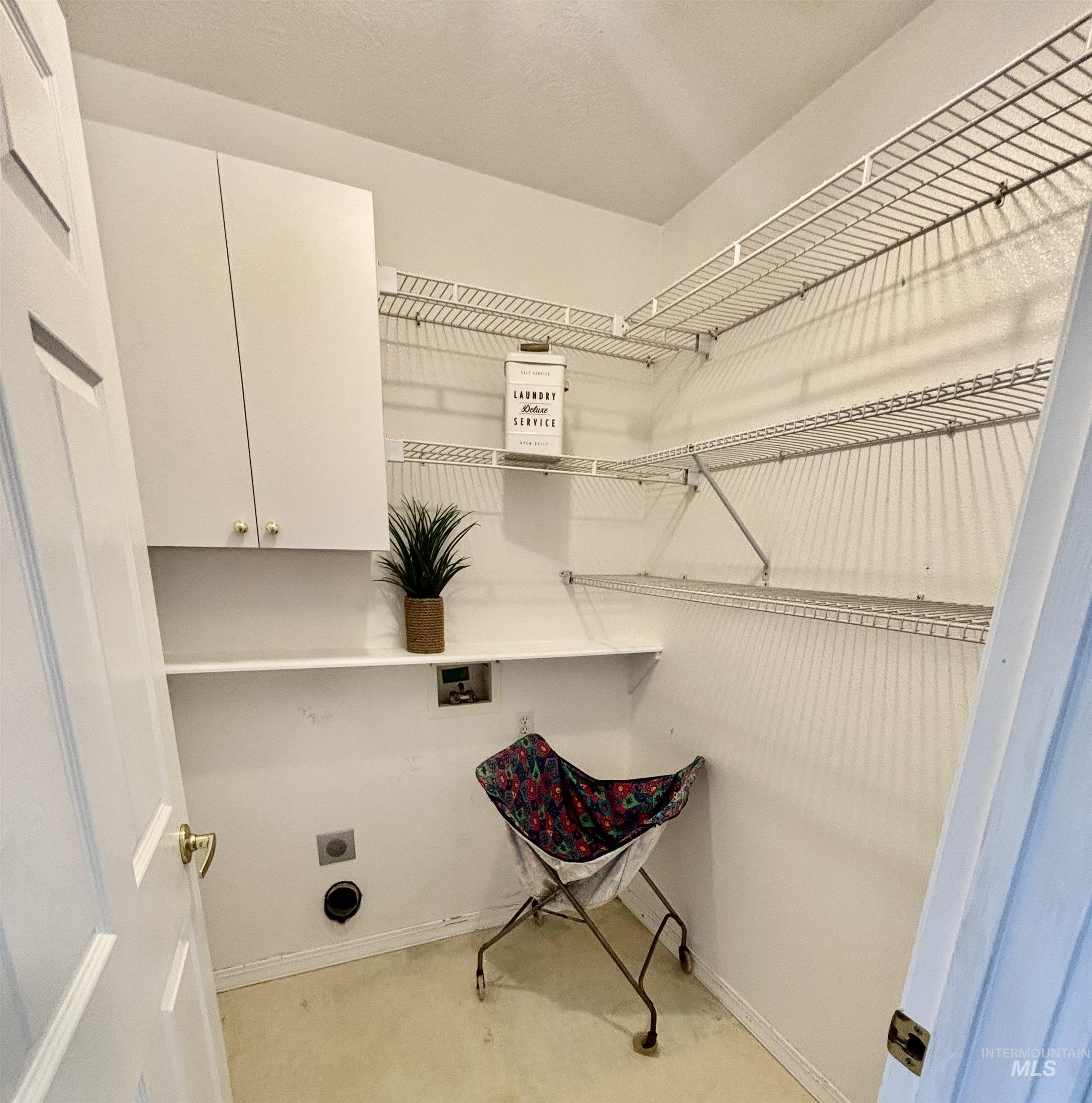 Washroom with cabinet space, washer hookup, and hookup for an electric dryer