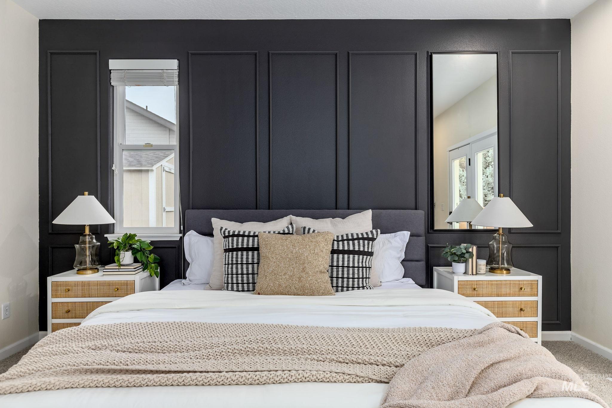 Bedroom with carpet flooring and a decorative wall
