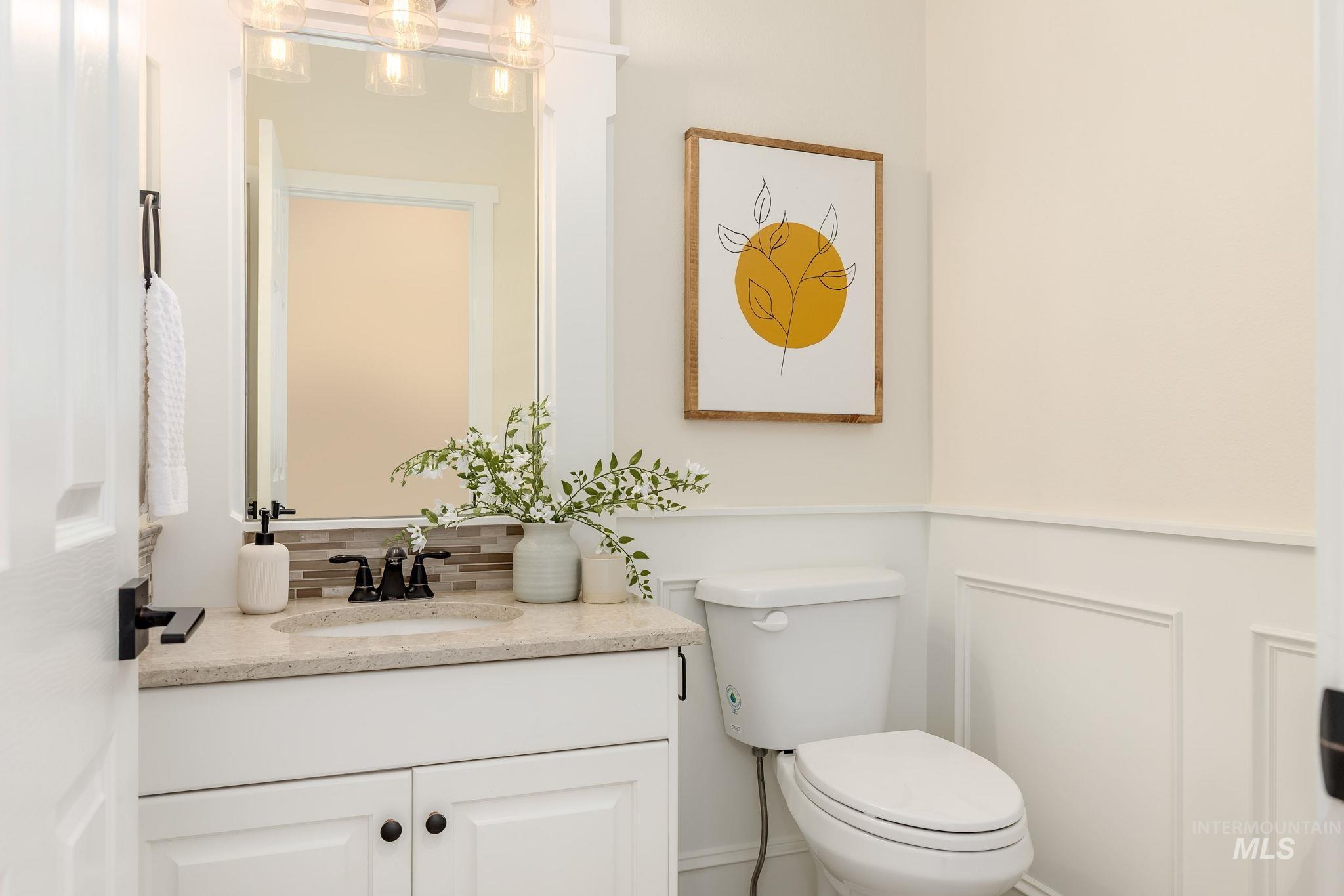 Bathroom featuring vanity and tasteful backsplash