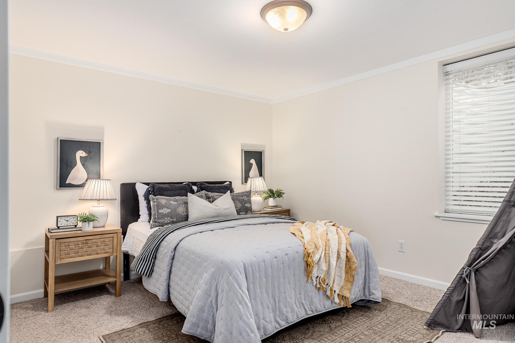 Bedroom featuring carpet floors and crown molding