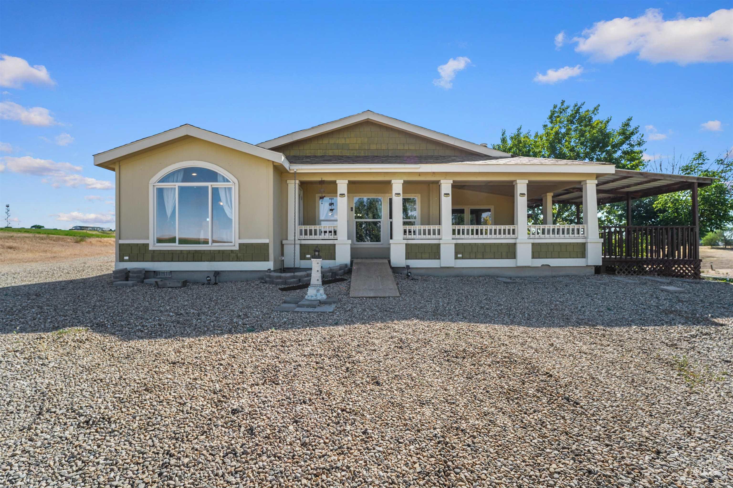 View of front of property with a large porch and crawl space