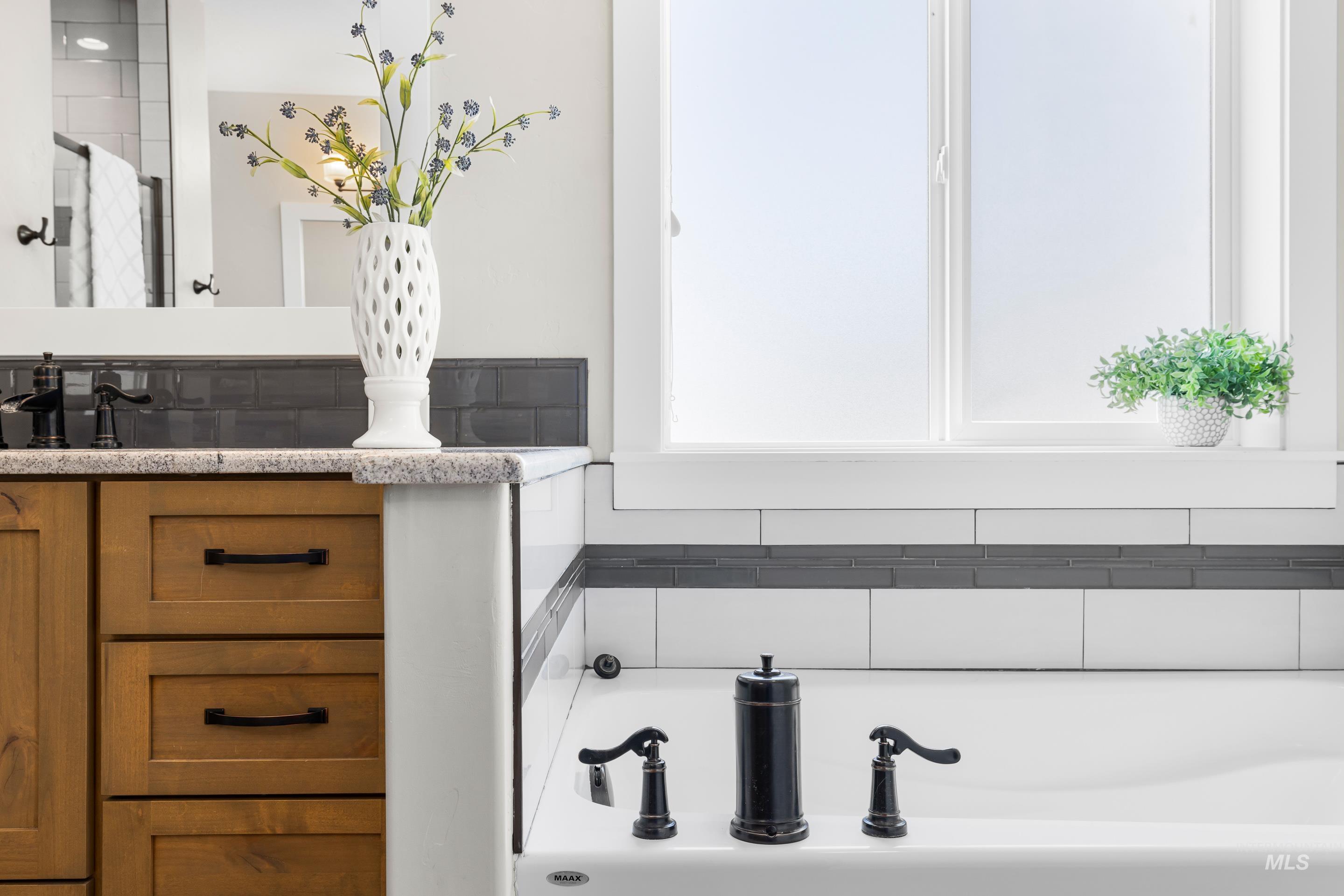 Bathroom with a bath, decorative backsplash, vanity, and a shower stall