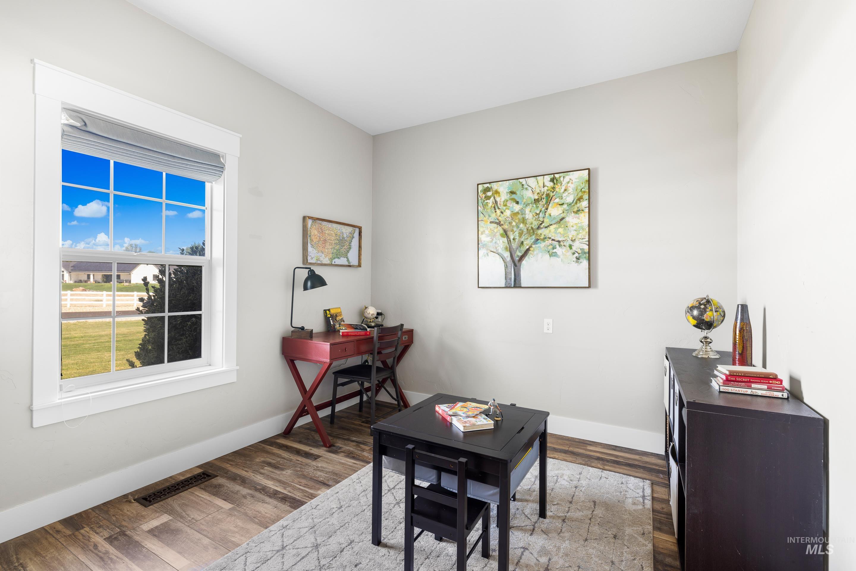 Home office with wood finished floors