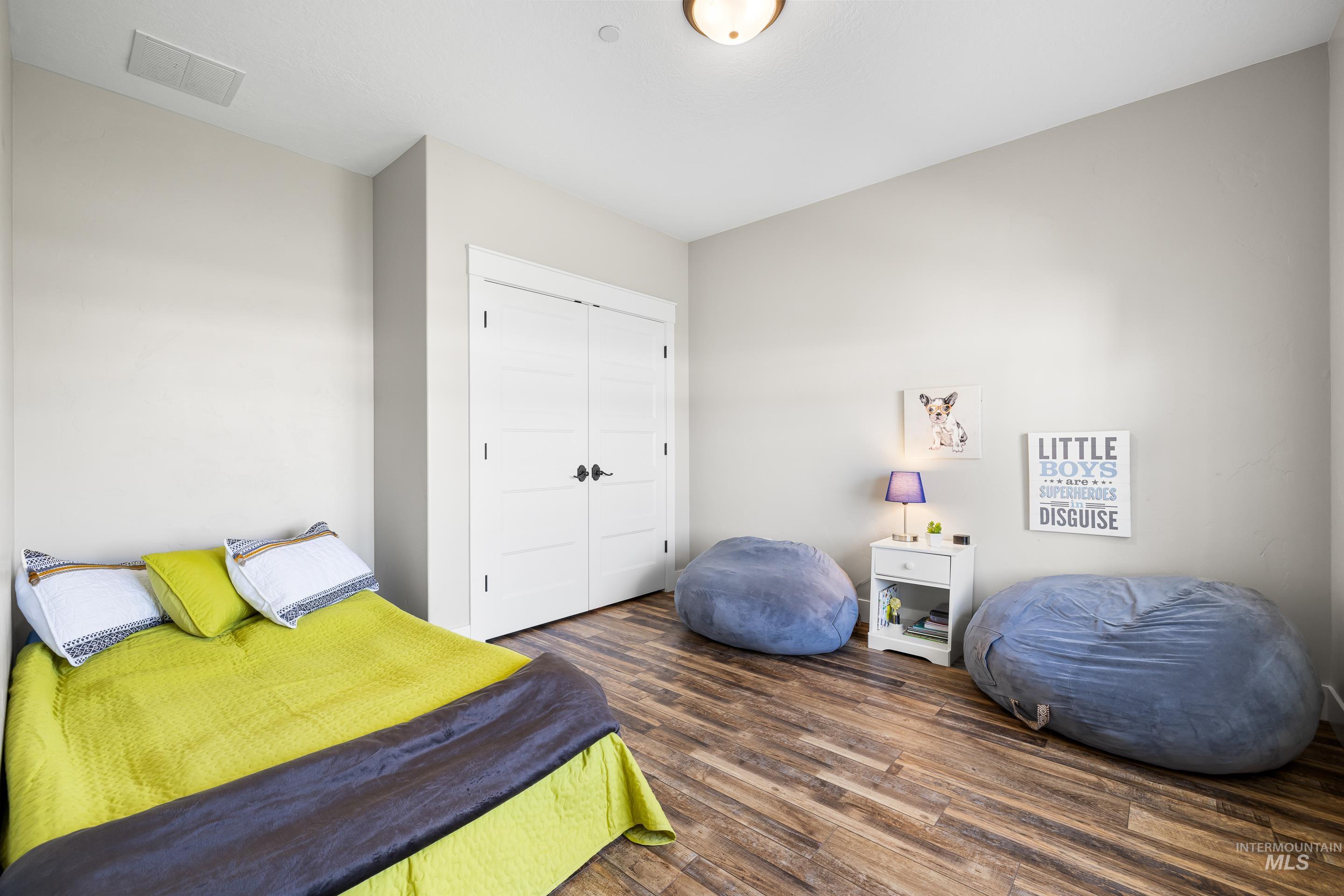 Bedroom featuring wood finished floors and a closet
