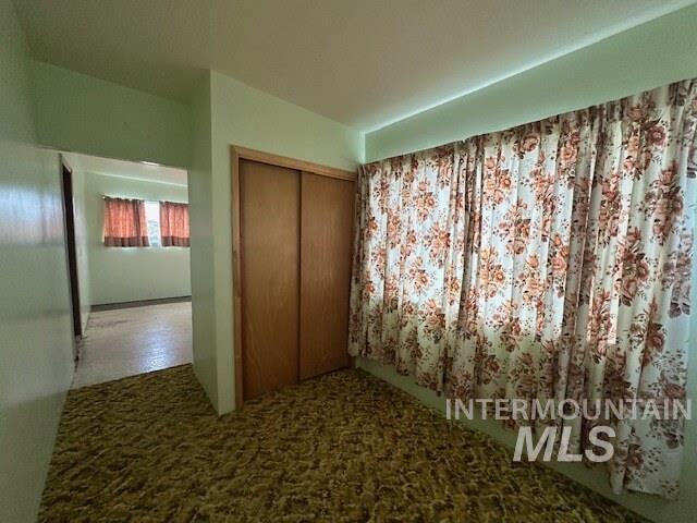 Unfurnished bedroom with carpet floors and a closet