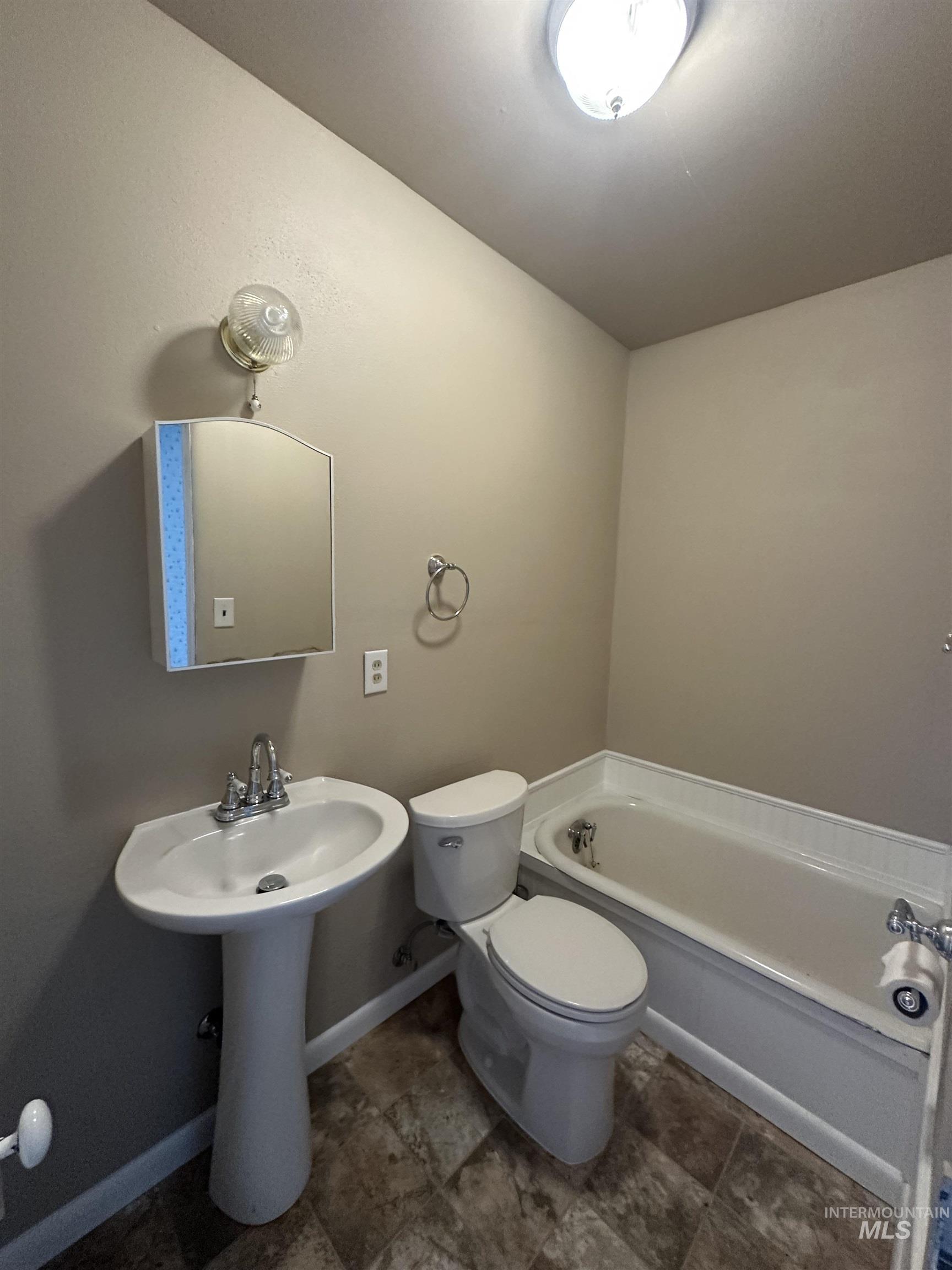 Bathroom featuring a bath and toilet
