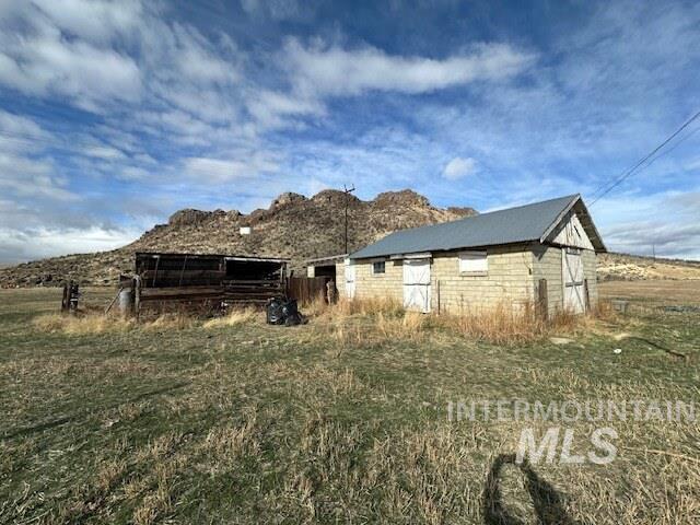 Rear view of house with an outdoor structure and an outbuilding