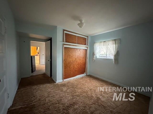 Unfurnished bedroom featuring carpet floors and a closet