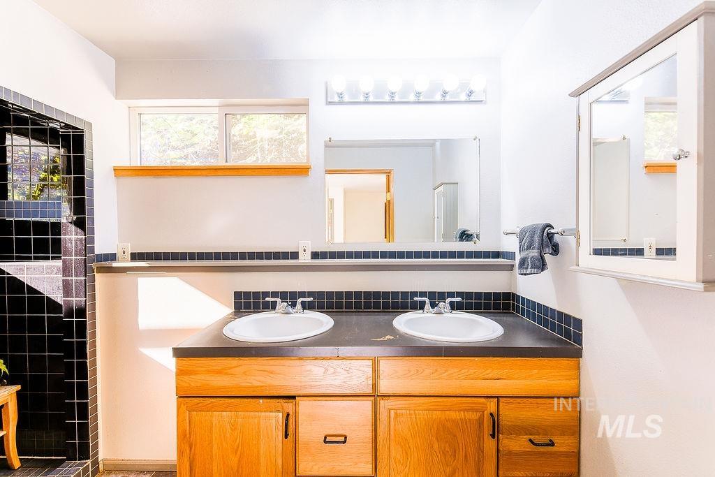 Full bath featuring double vanity