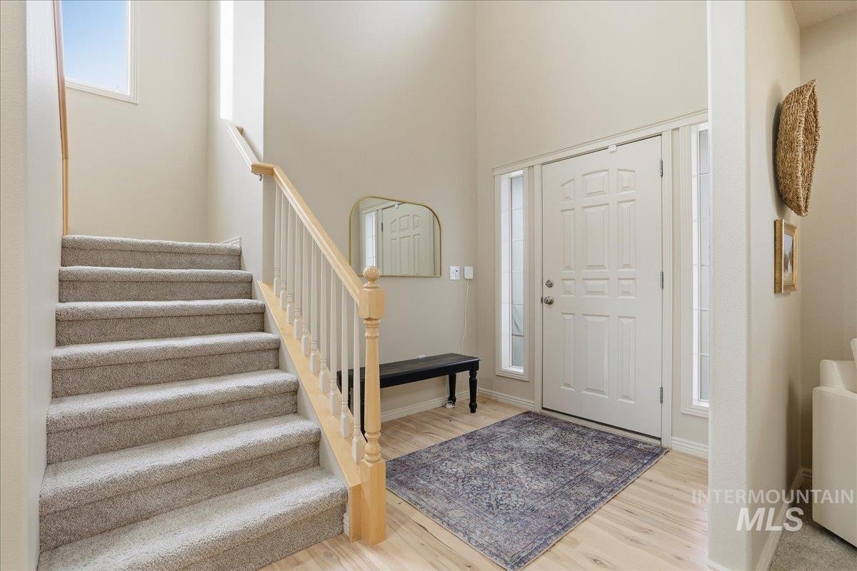 Foyer entrance featuring stairway and wood finished floors