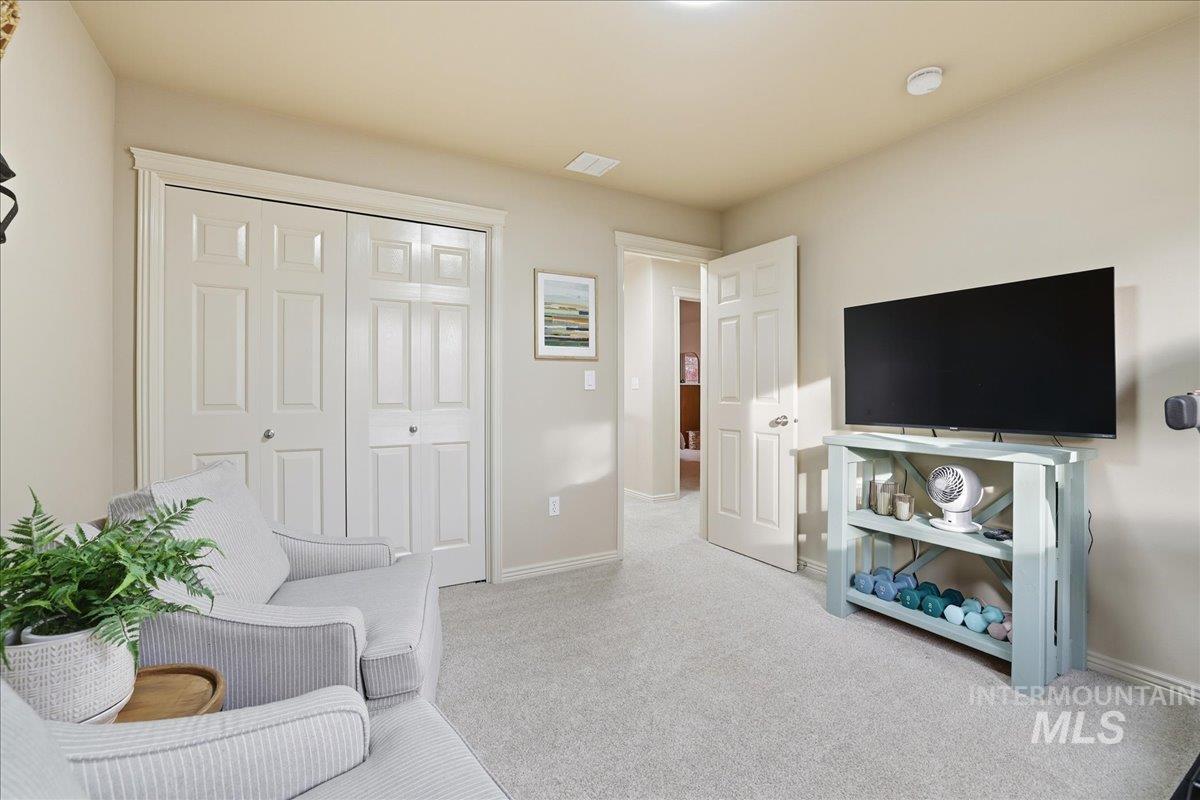 Living area featuring carpet floors and baseboards