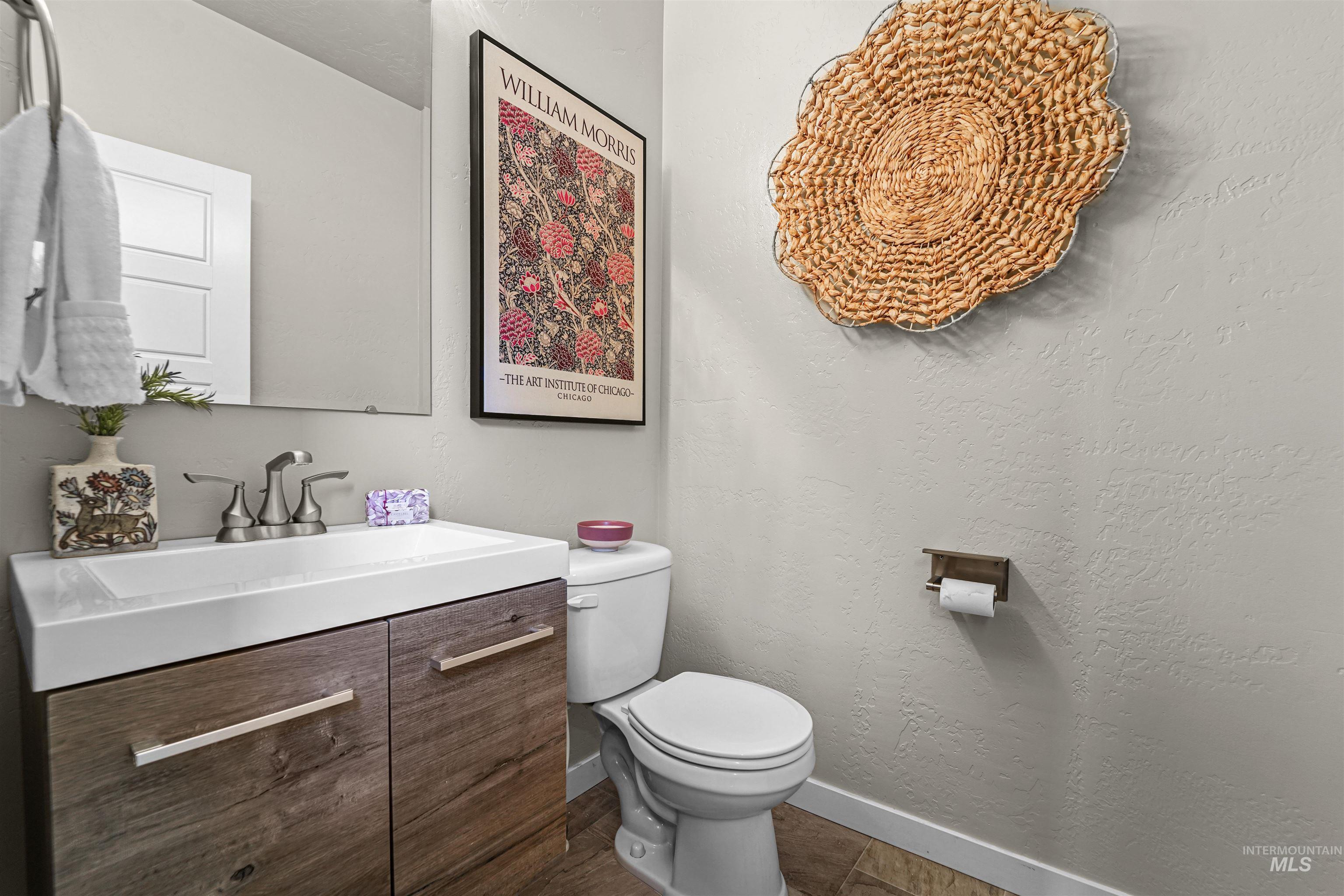 Bathroom featuring vanity and a textured wall